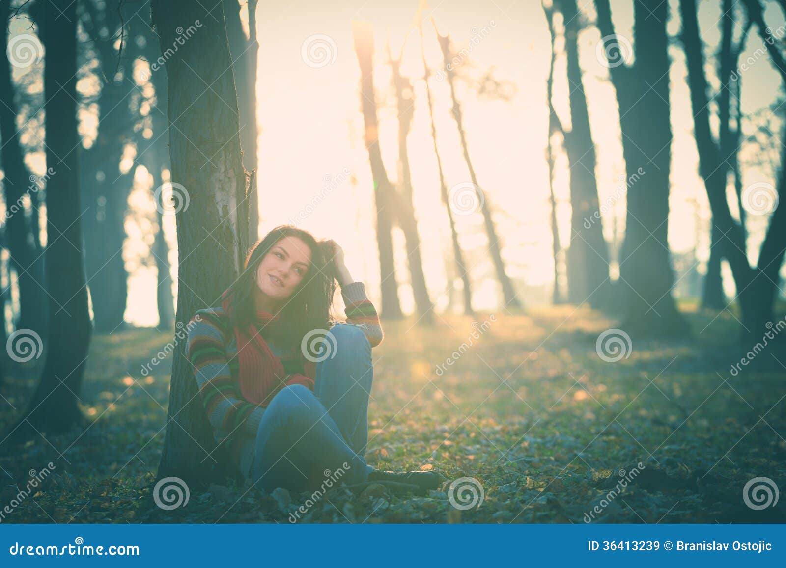 Rest in forest. Young woman in casual clothes rest by tree in forest retro colors