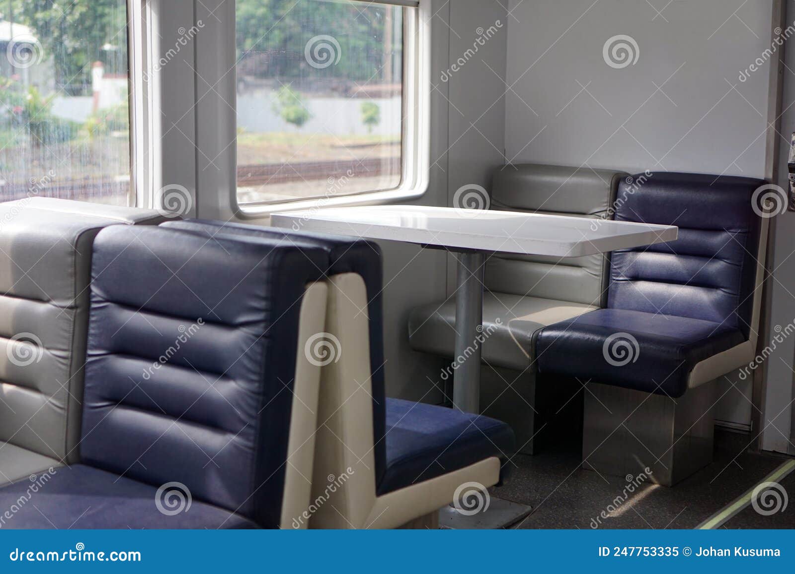 Restaurant Chairs and Tables in the Dining Train Carriage of an