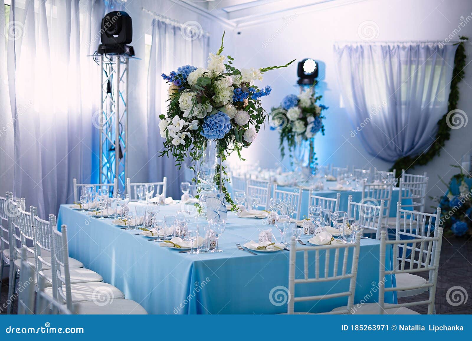 the restaurant has beautiful tables with serving, the decor is made in blue, tables are indicated with flowers and beautiful