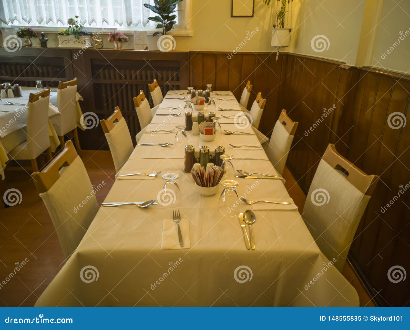 A Restaurant Interior With Fancy Old Tables And Chairs