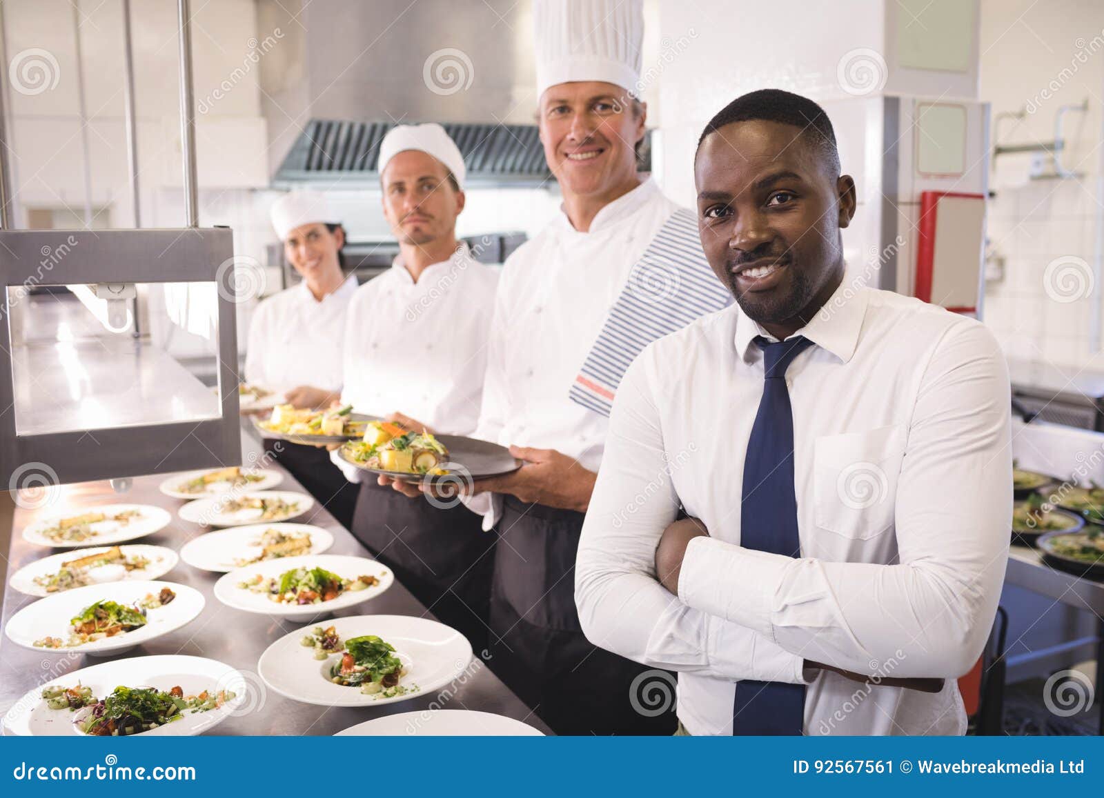restaurant manager with his kitchen staff
