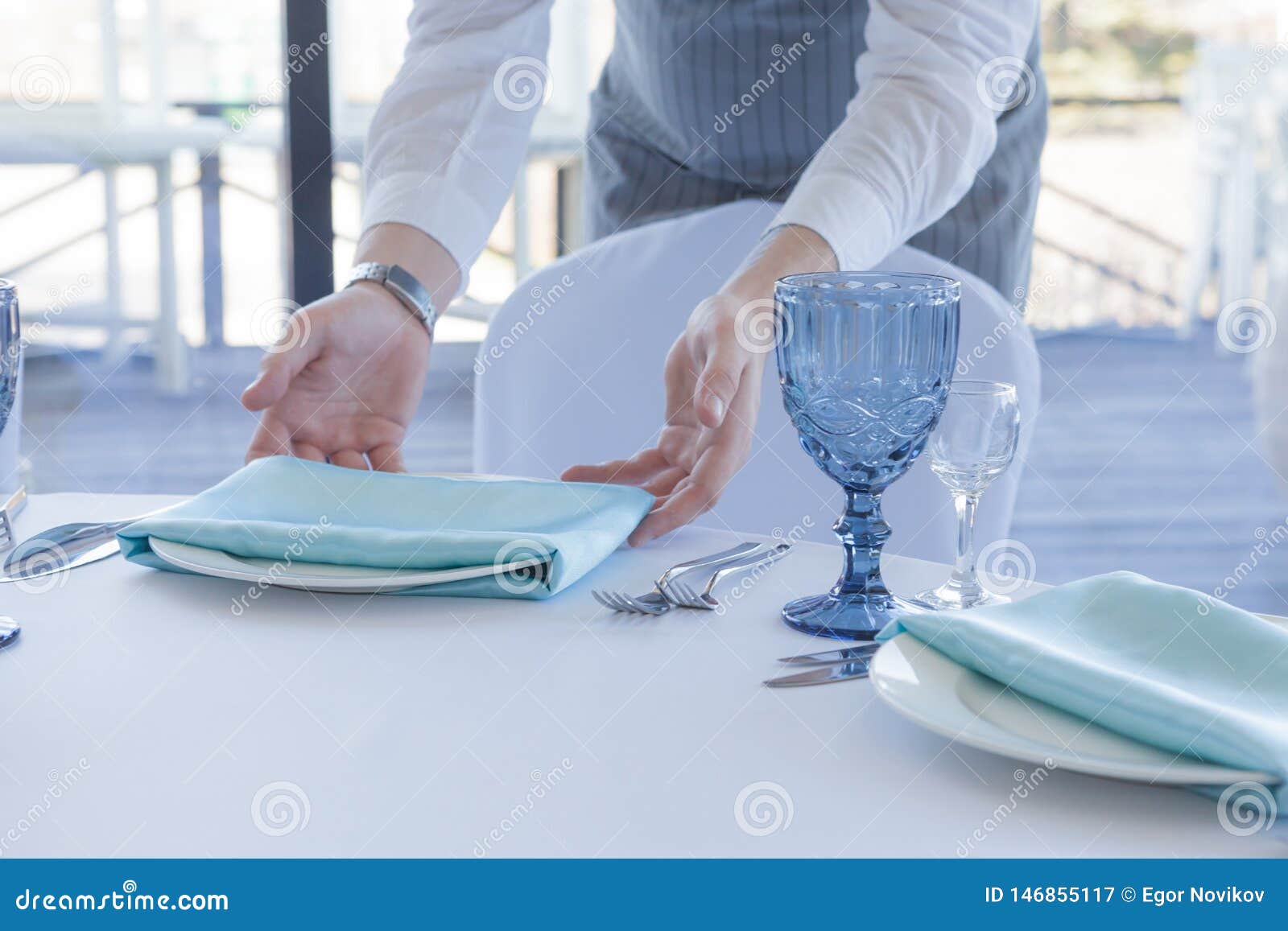 restaurant waiter serves a table for a wedding celebration
