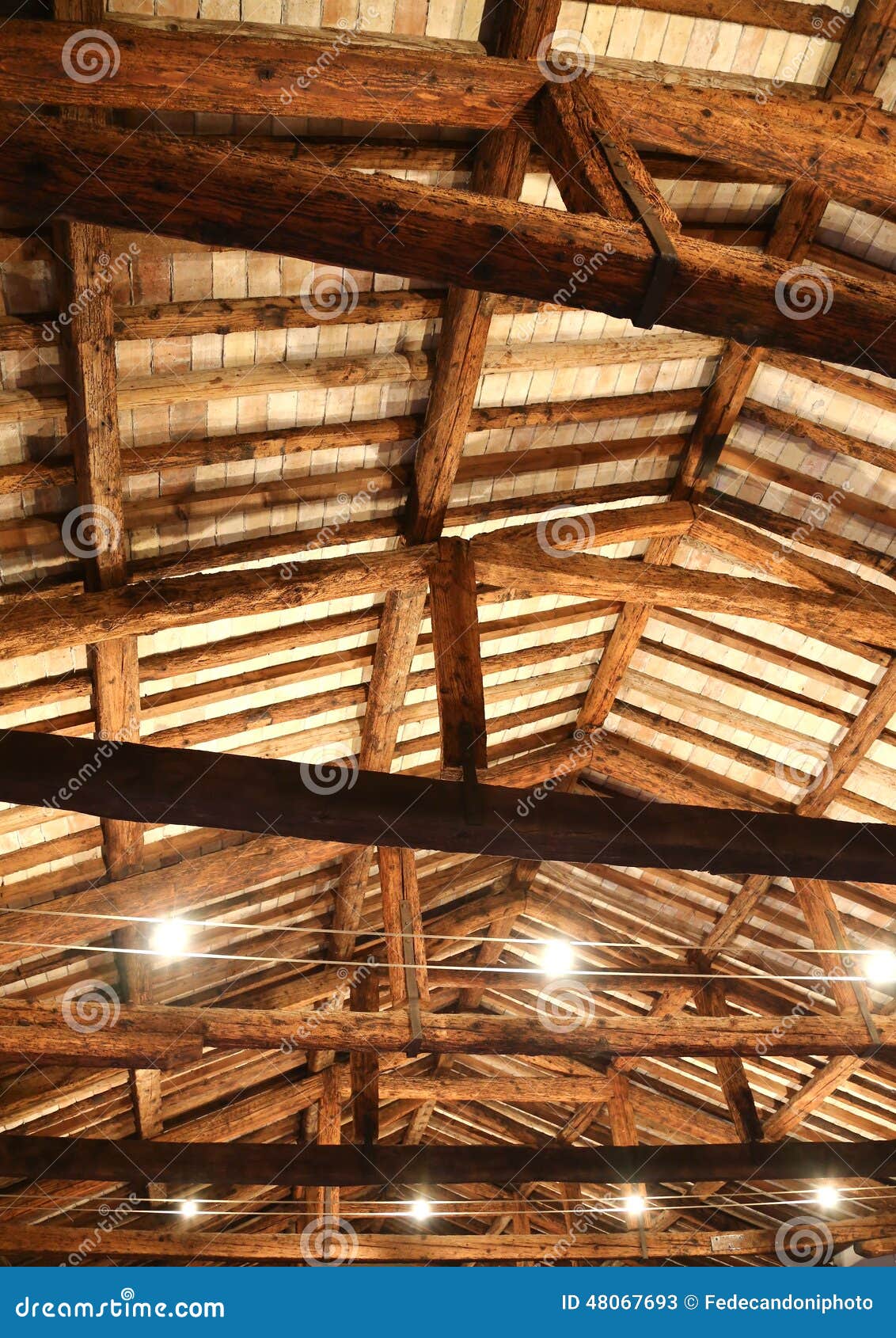 restored roof with wooden beams and the lamps