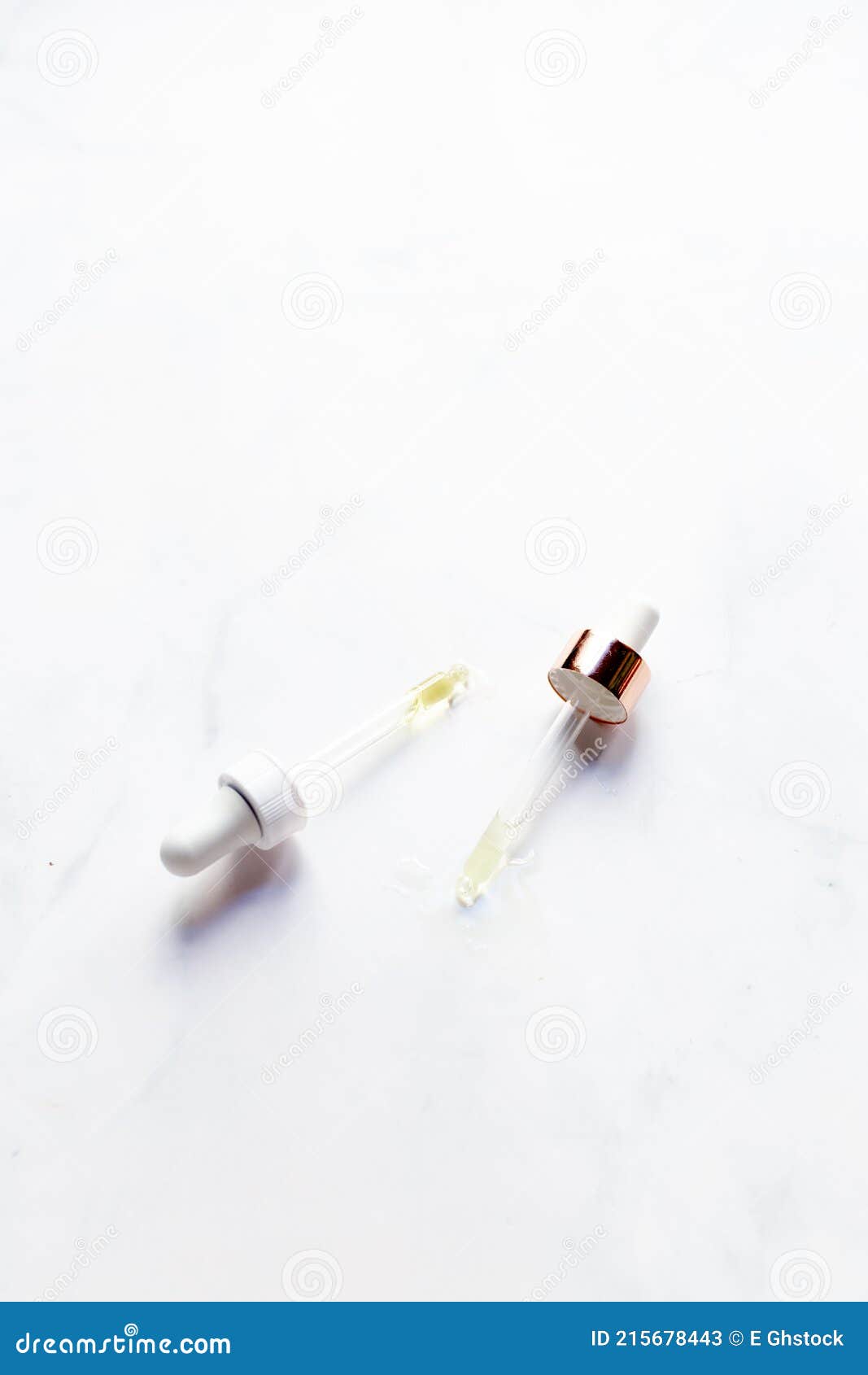 retinol oil serum oil pipettes on  marble background. beauty care concept