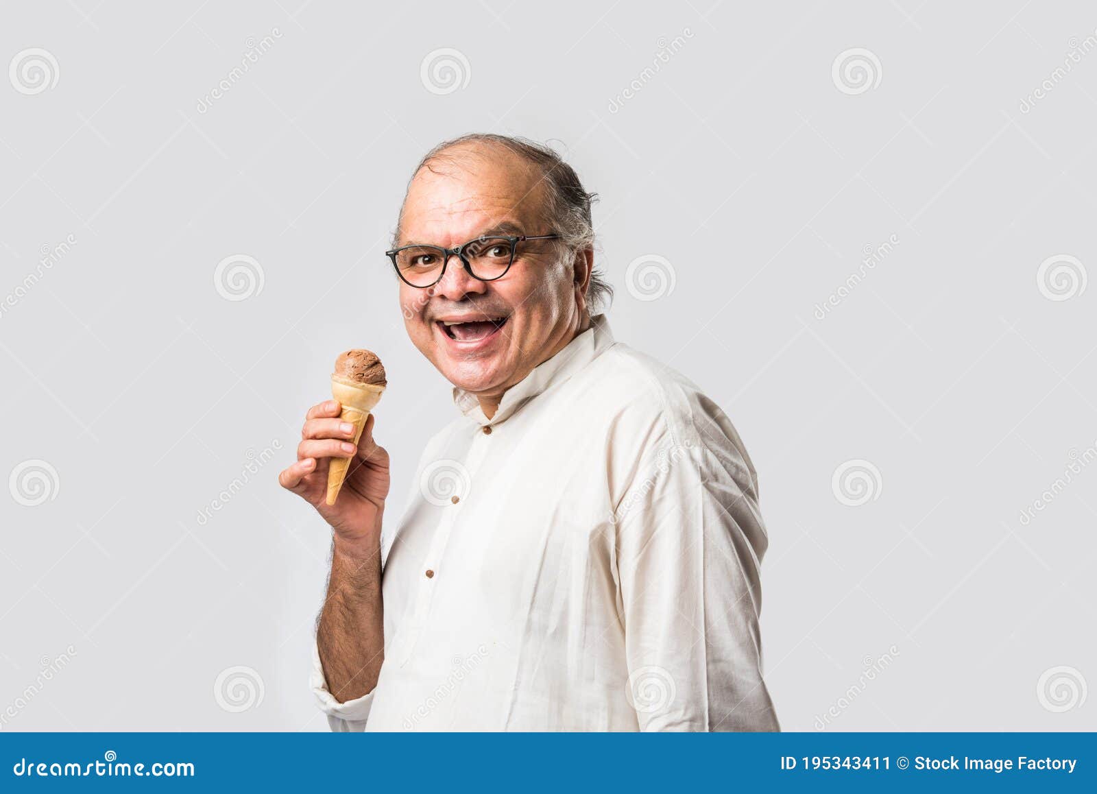 retired indian old man eating ice cream, standing icolated against white background