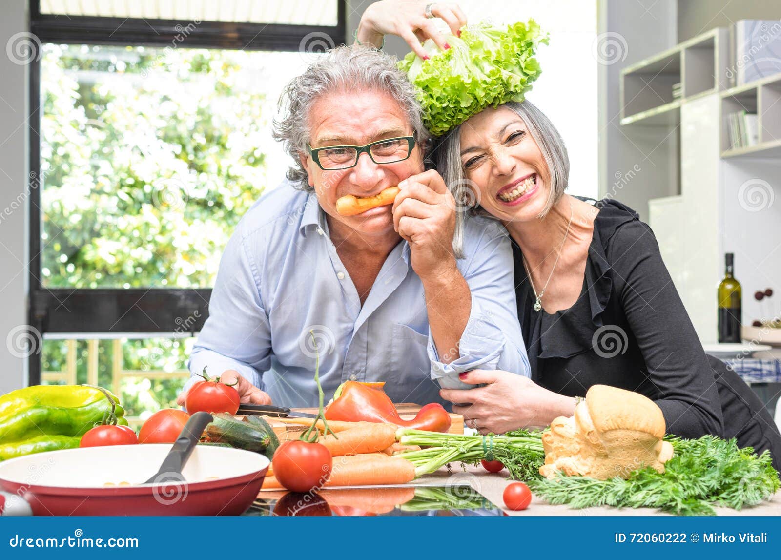  Retired  Senior Couple  Having Fun In Kitchen With Healthy 