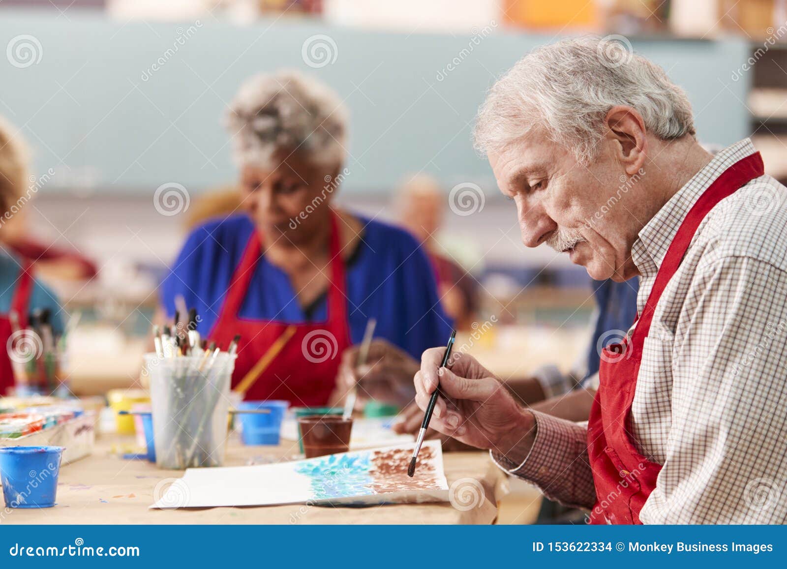 Retired Senior Man Attending Art Class in Community Centre Stock Photo