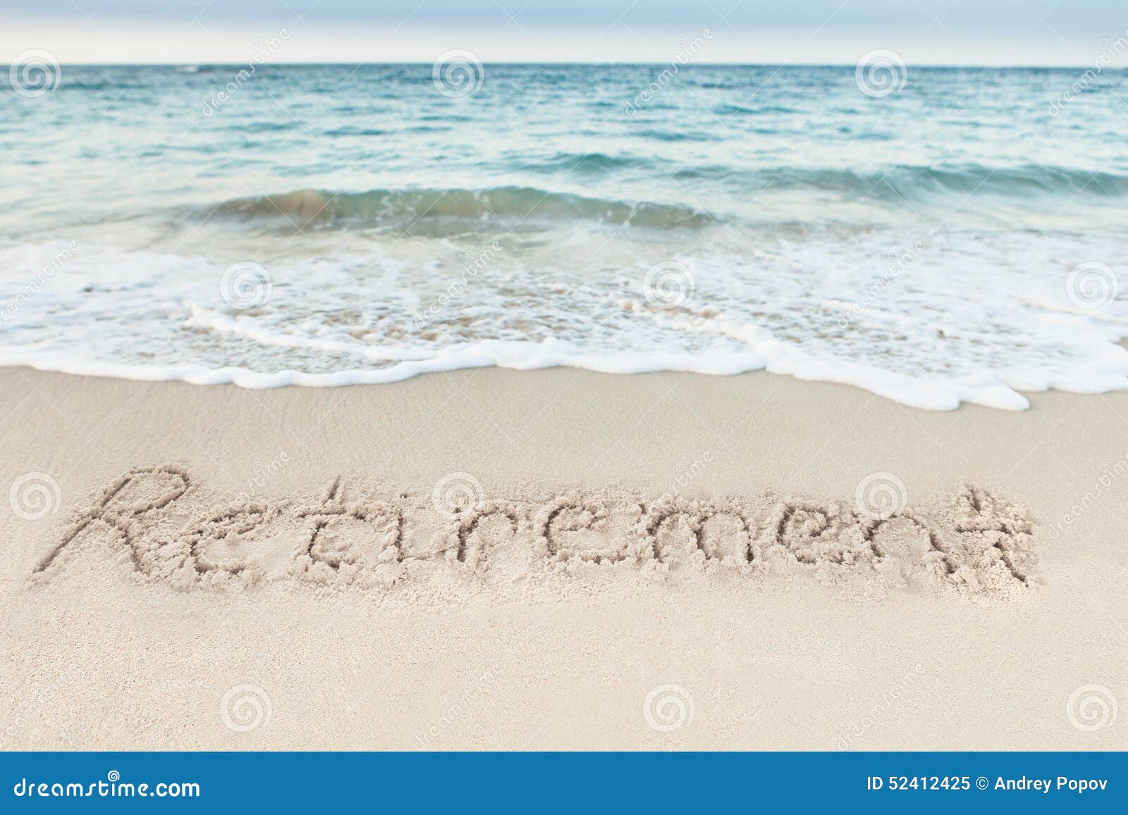 retirement written on sand by sea