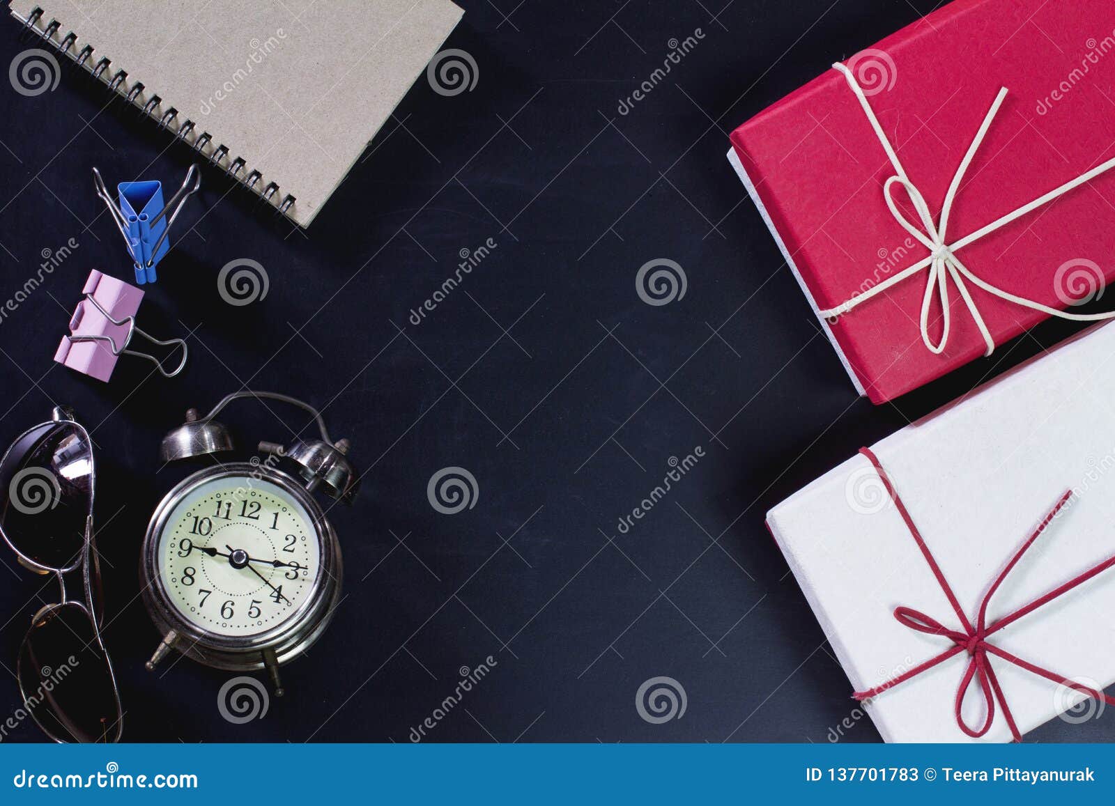 Retro Clock with Gift Box and Office Supplies on Blackboard. Stock