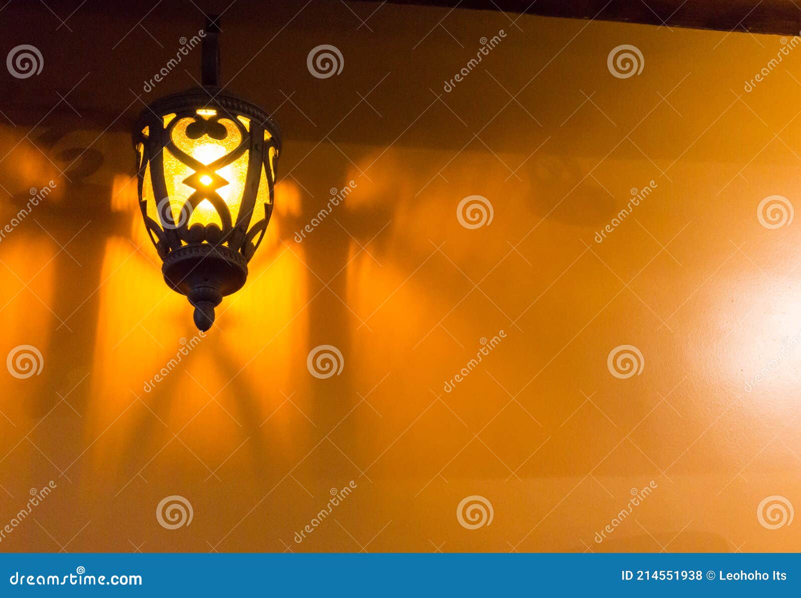 A Vintages Lamp Hanging on Wall. Old Light Glowing in the Dark Stock