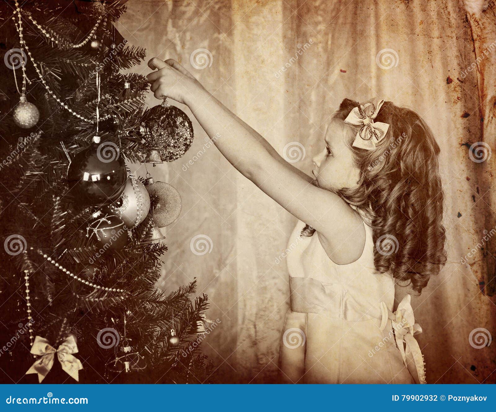 retro old portrait of child decorate on christmas tree.