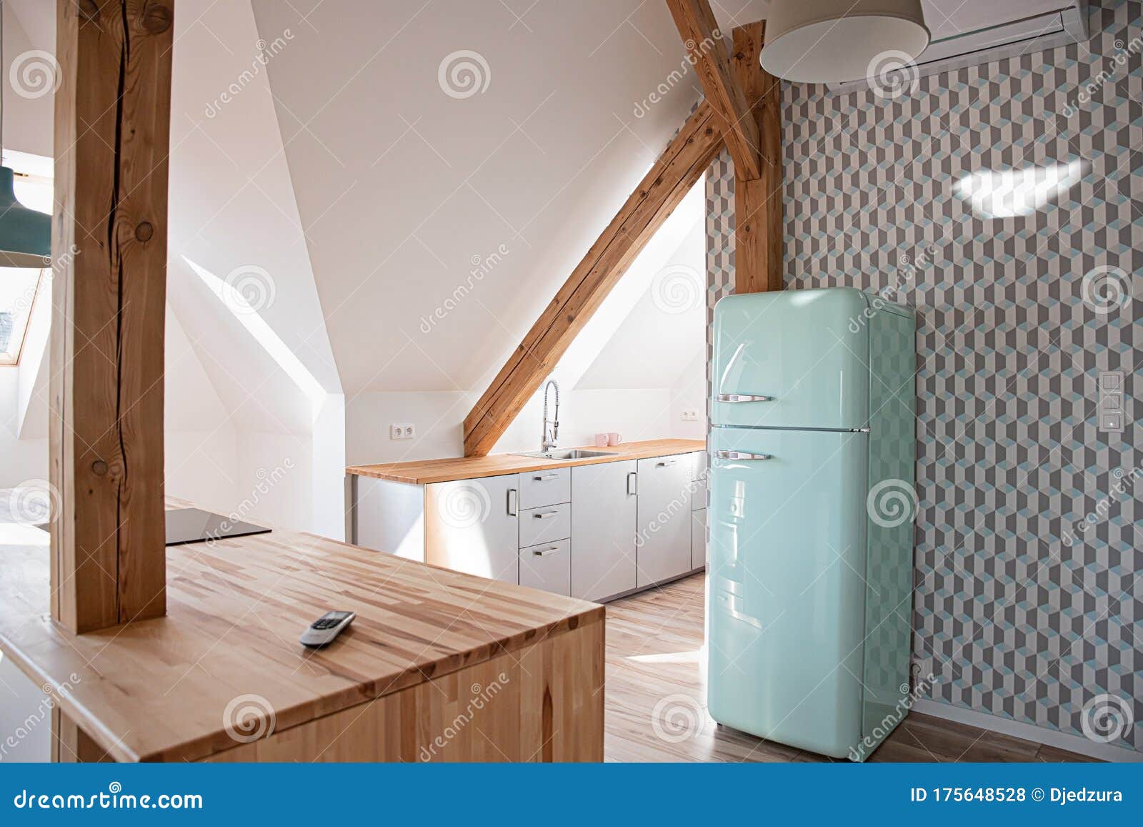 Retro Refrigerator in Bright Attic Kitchen in Loft Apartment Stock