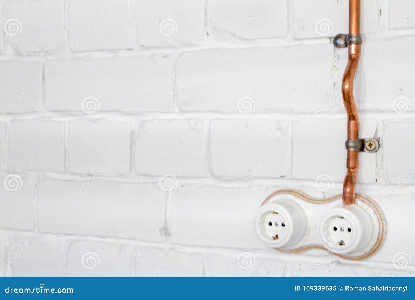 A Vintage Outlet and Electrical Wiring in a Copper Tube. Stock Image