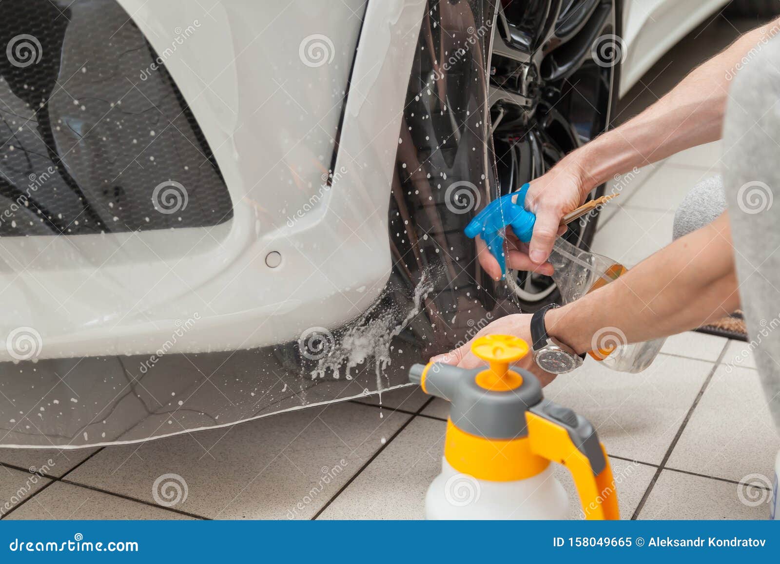 Retrofitting The Car With A Solid Transparent Protective Film The Master Splashes Water On The Coating Protecting The Vehicles Stock Image Image Of Protect Automobile 158049665