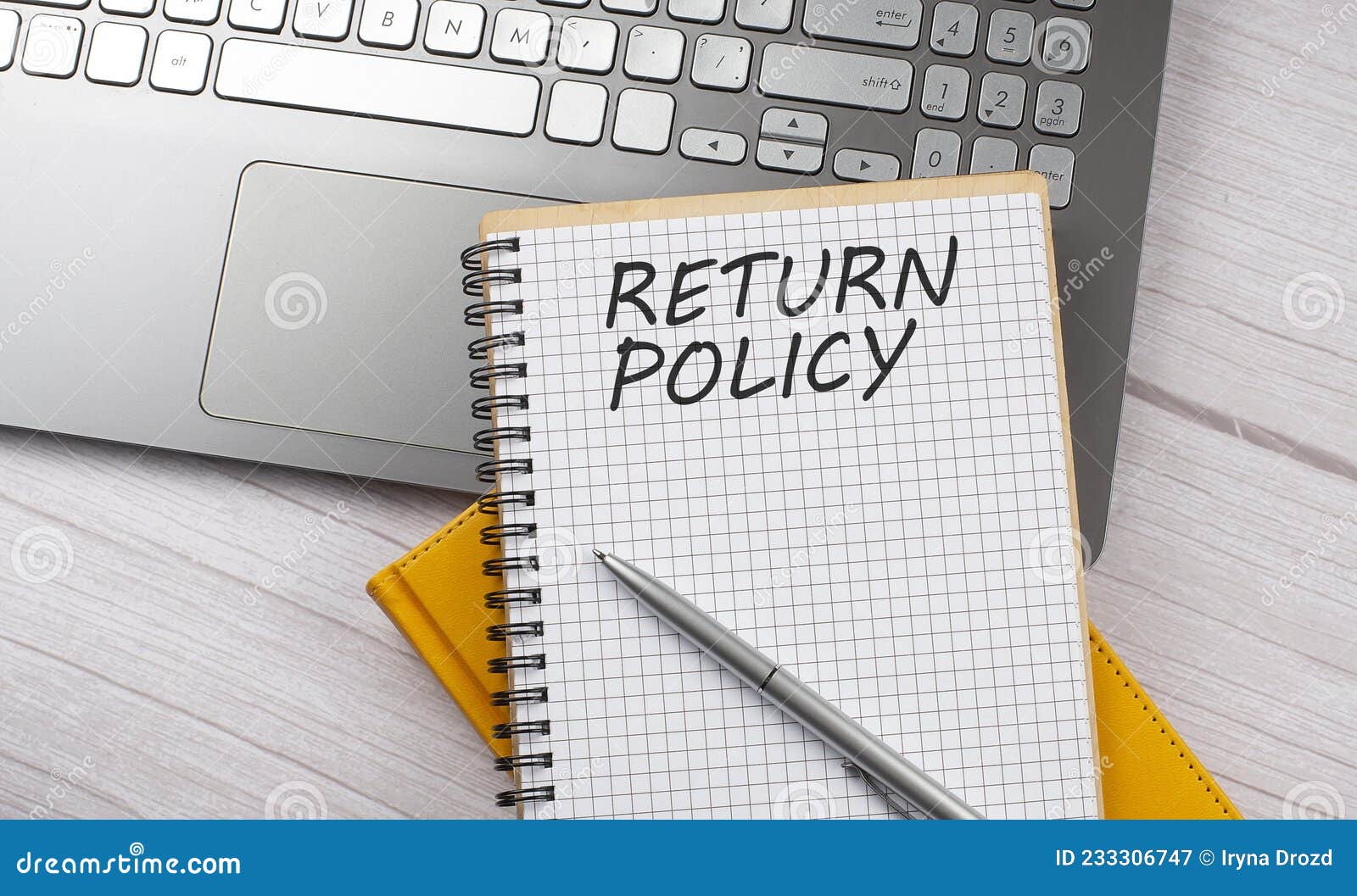 return policy text written on a notebook on the laptop,business