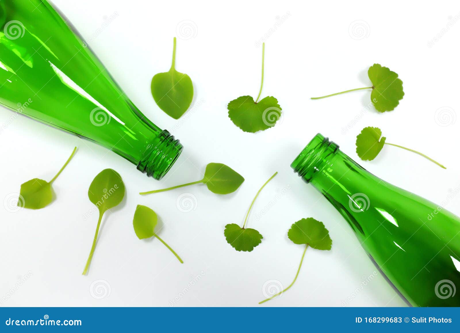 reusable glass bottles and green leaves showing reduce, reuse, recycle concept
