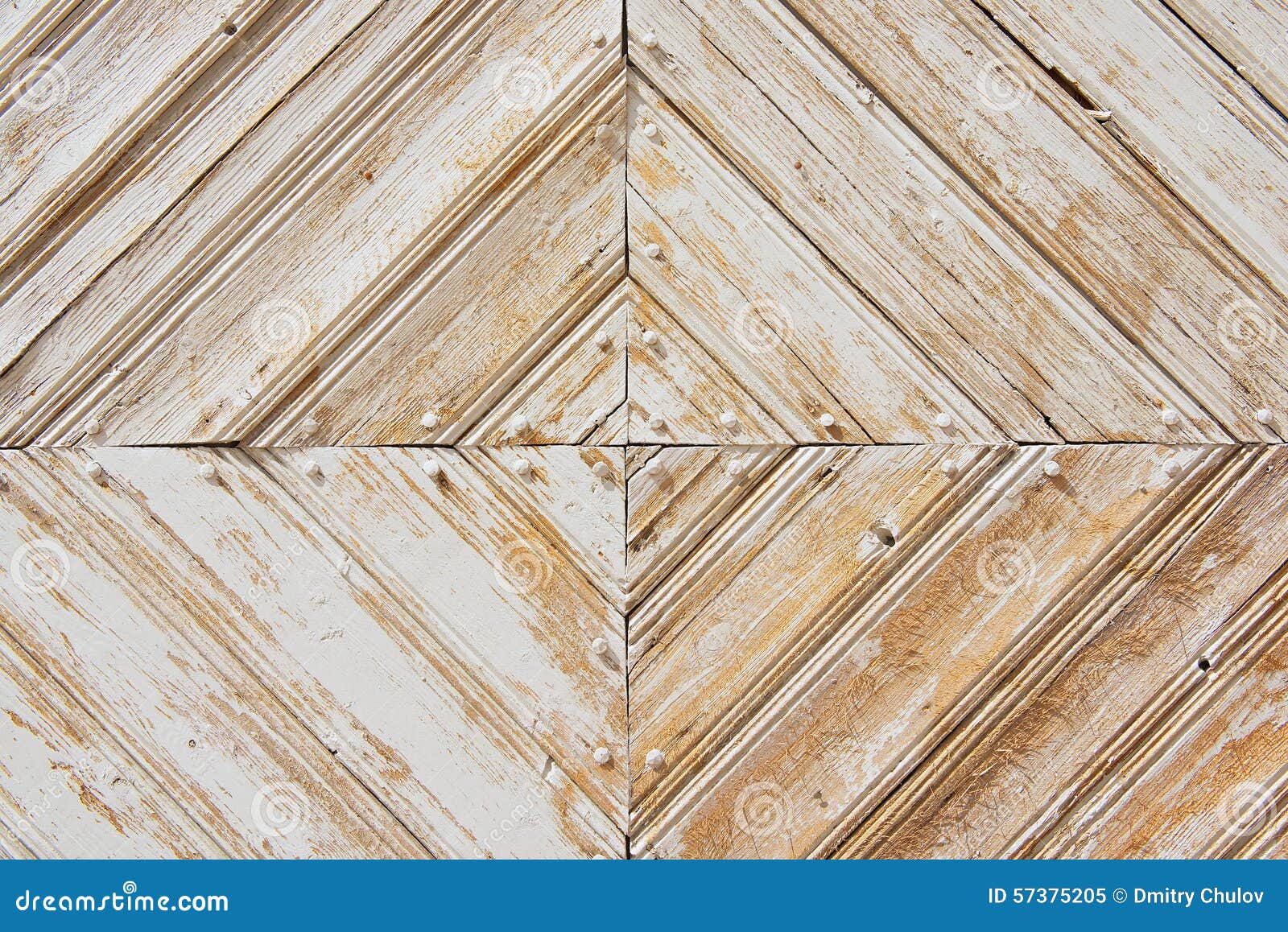 rhomb pattern of the old weathered white-painted wooden gate.