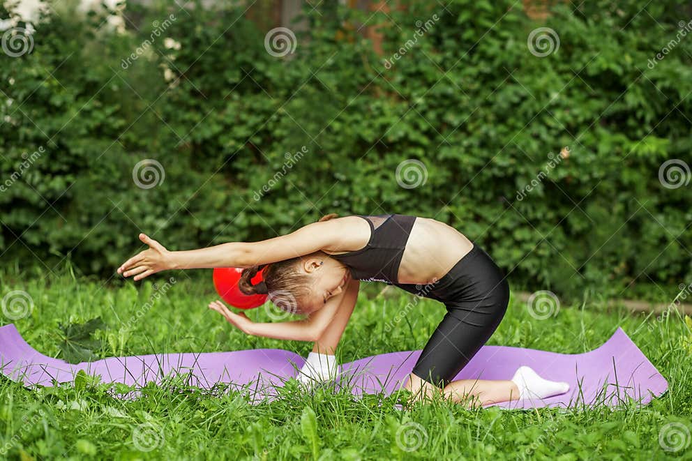 Rhythmic Gymnastics. Preteen Child Gymnast Performs an Exercise with ...