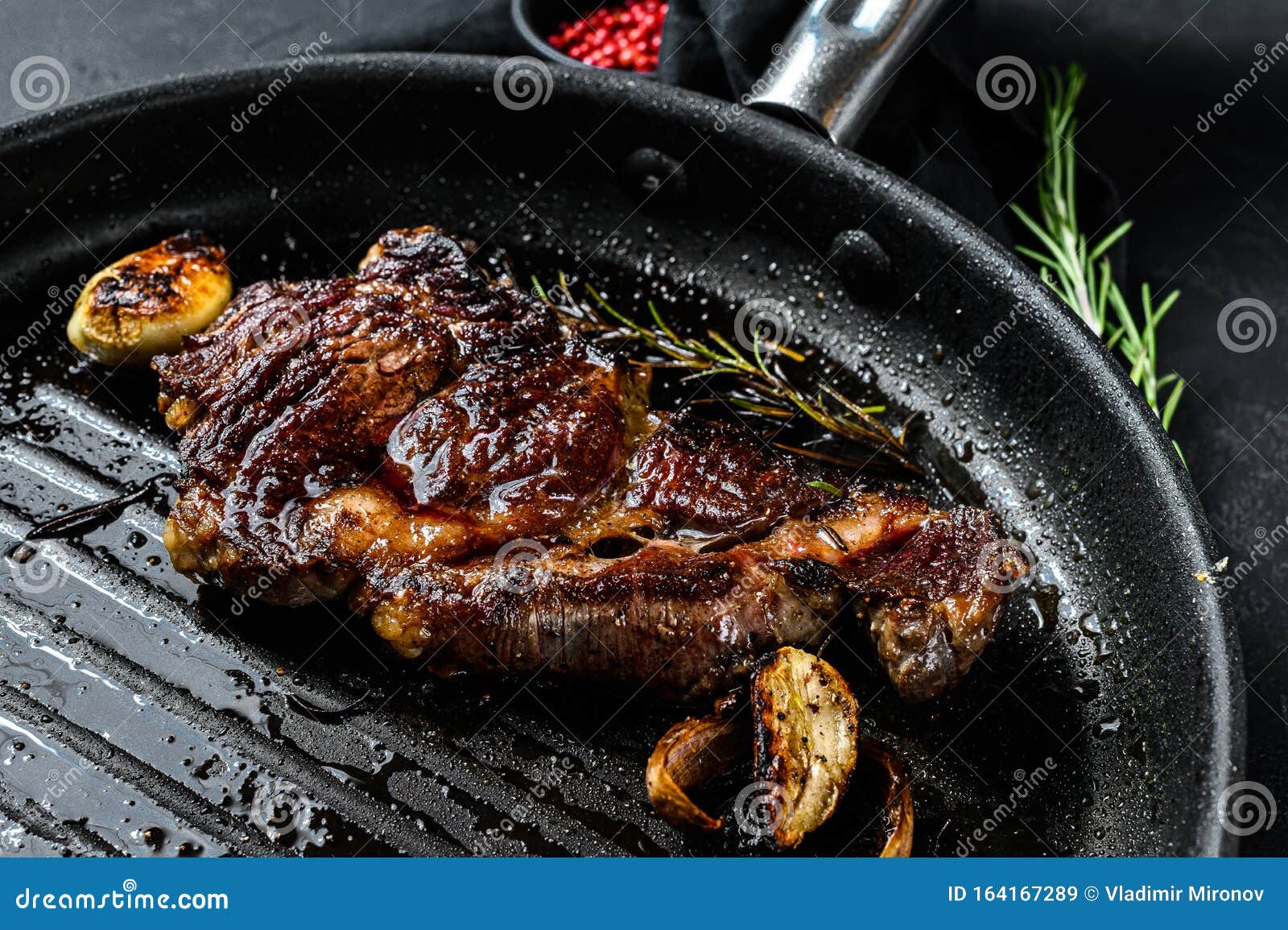 Rib Eye Steak on a Grill Pan. Roast Beef. Black Background Stock Image