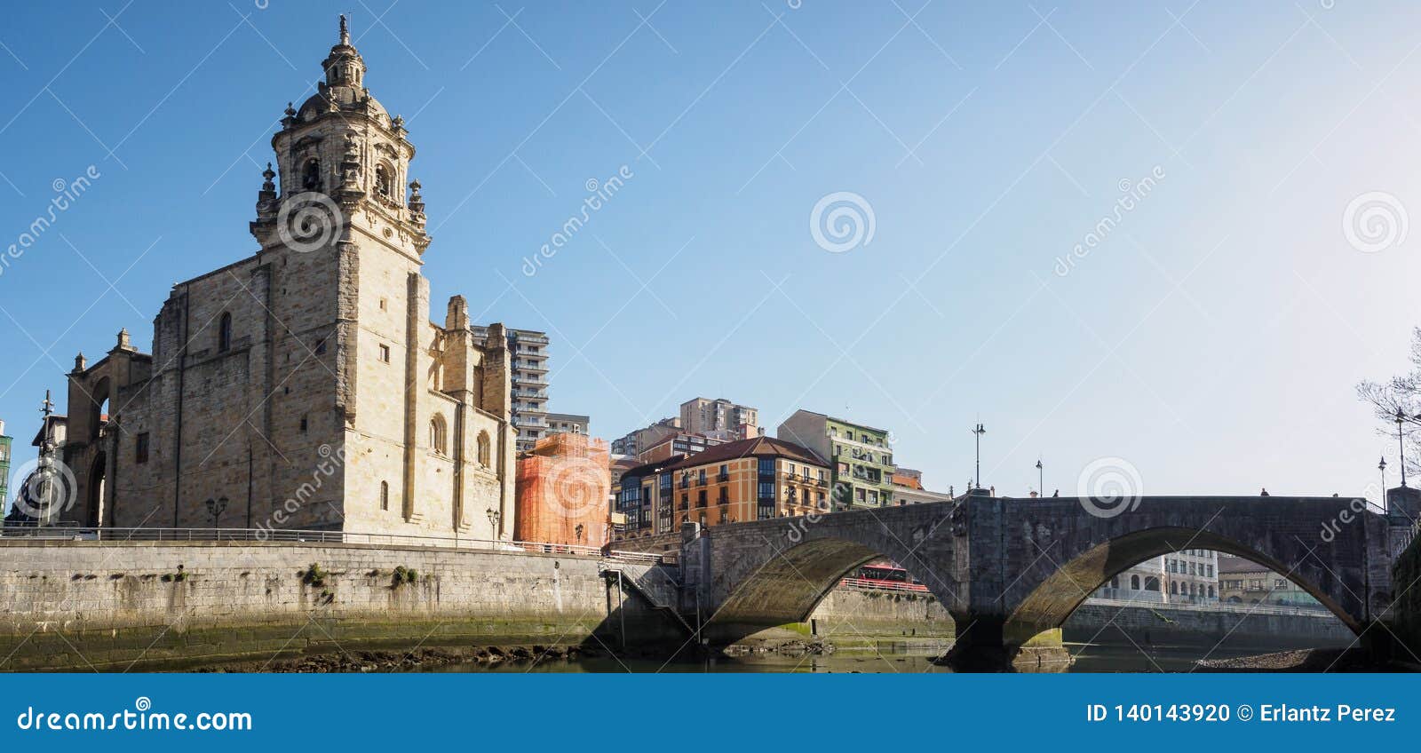 the ribera market and the church of san anton of bilbao seen from the river