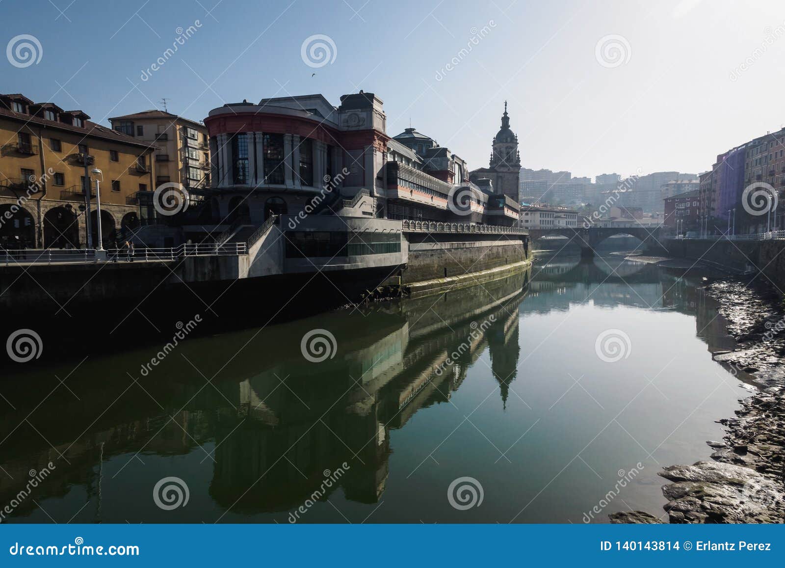 the ribera market and the church of san anton of bilbao seen from the river