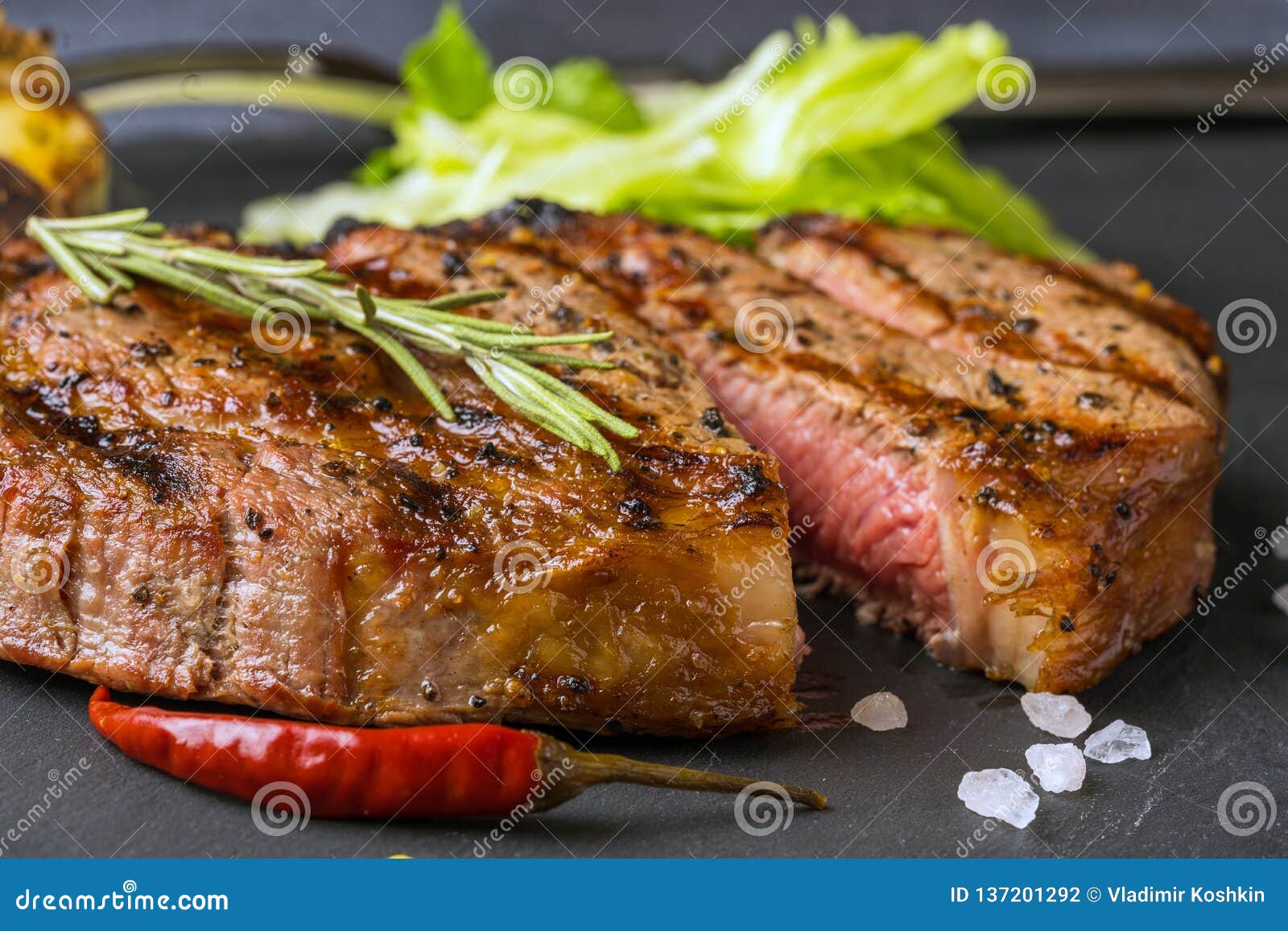 A ribeye steak with green stock photo. Image of view 137201292