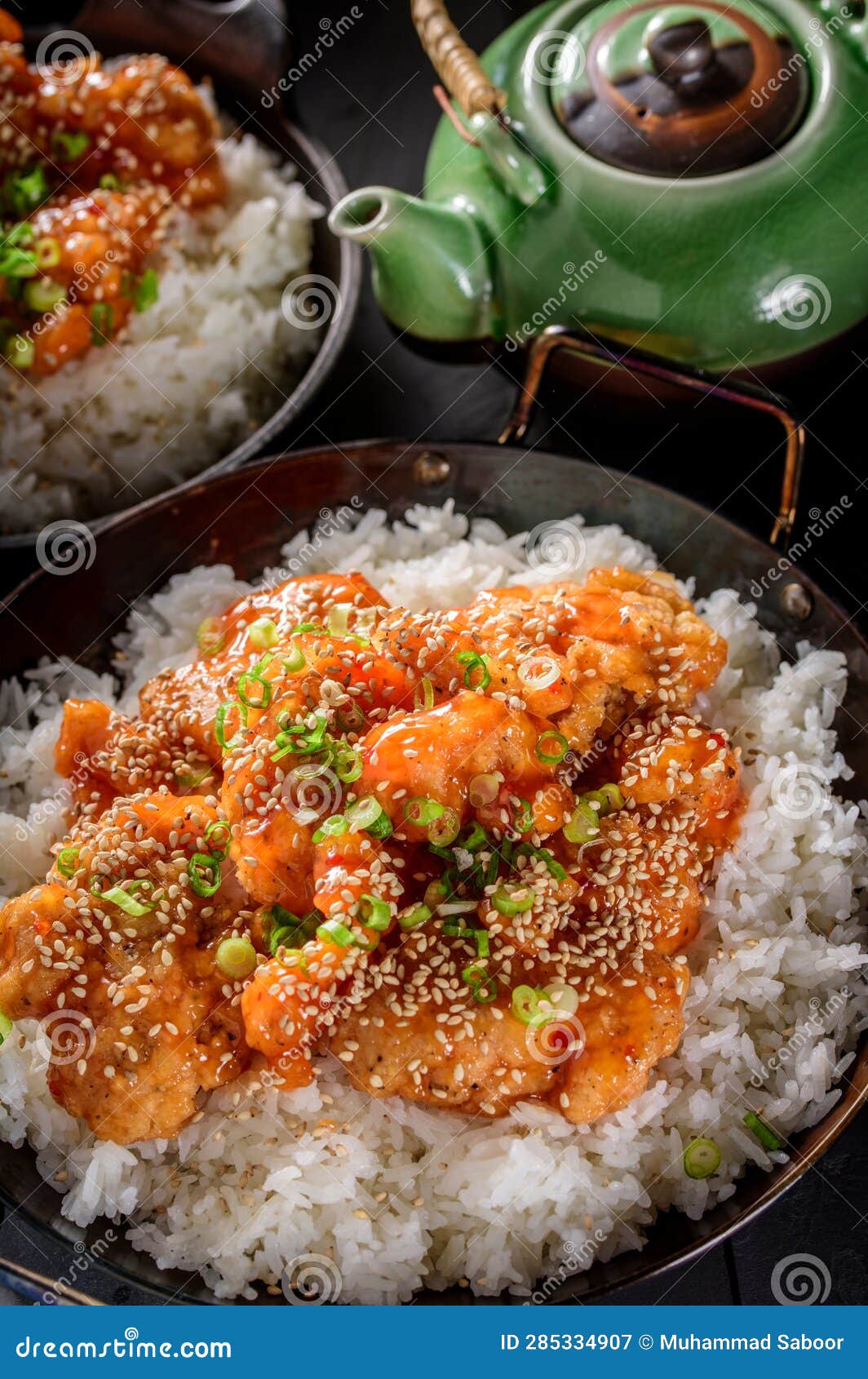DeepFried Orange Chicken Served on a Bed of Steamed White Rice