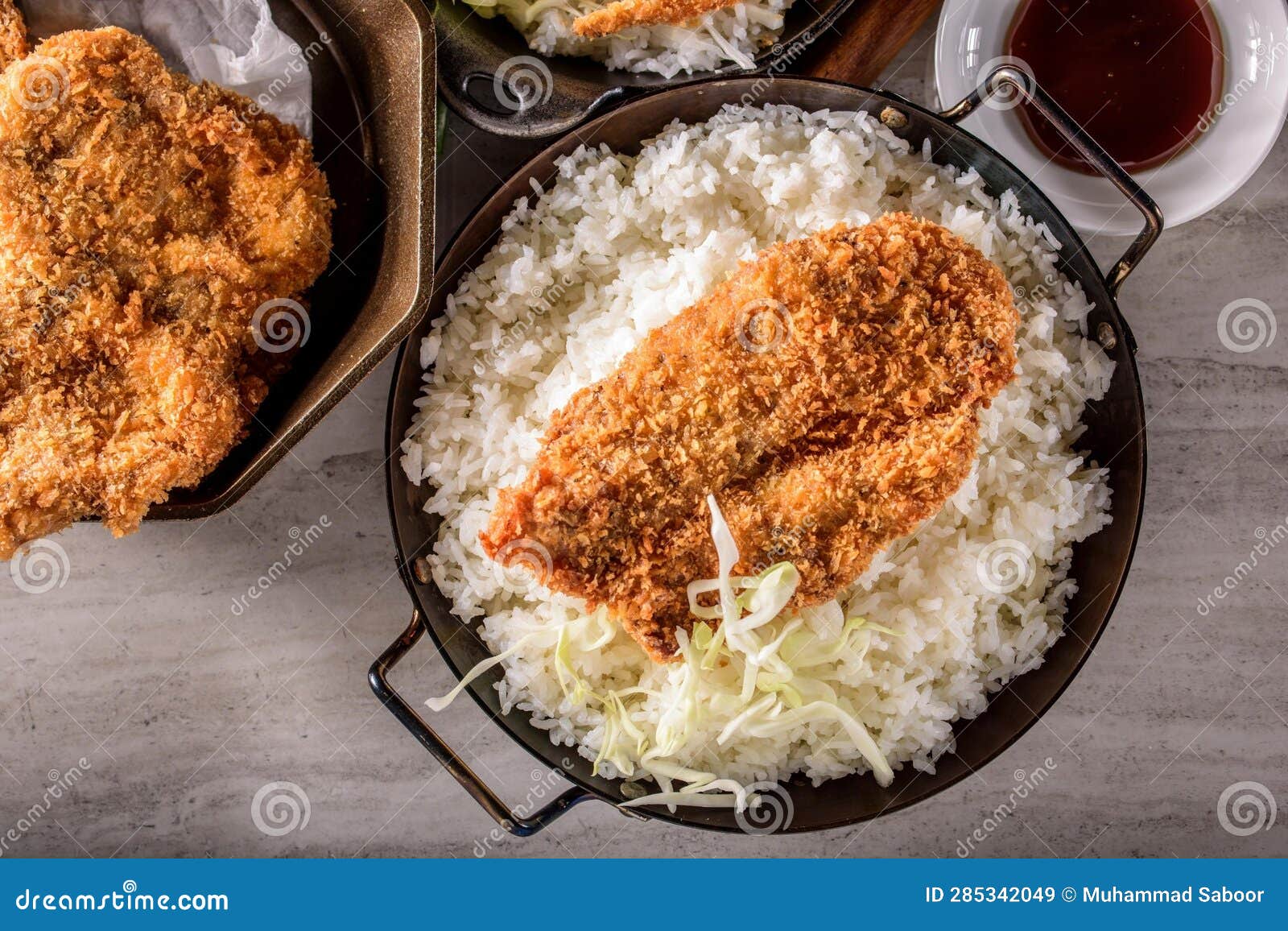 DeepFried Orange Chicken Served on a Bed of Steamed White Rice