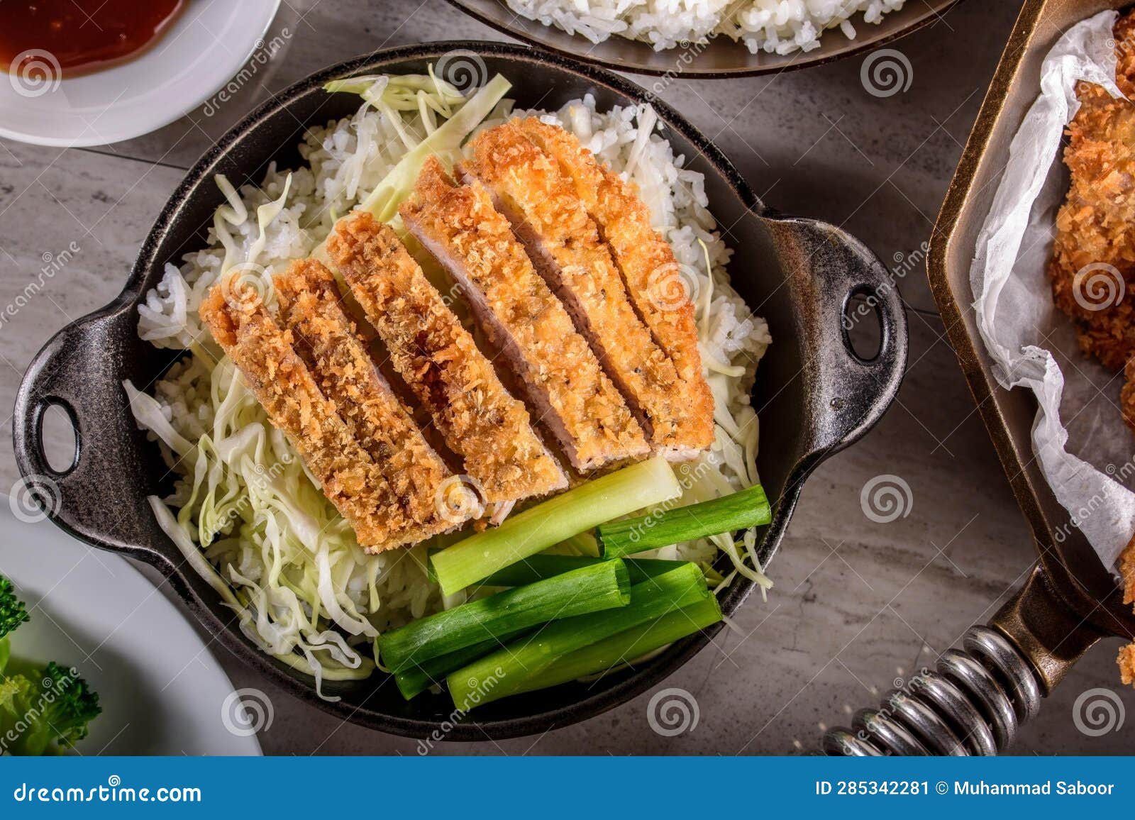 DeepFried Orange Chicken Served on a Bed of Steamed White Rice