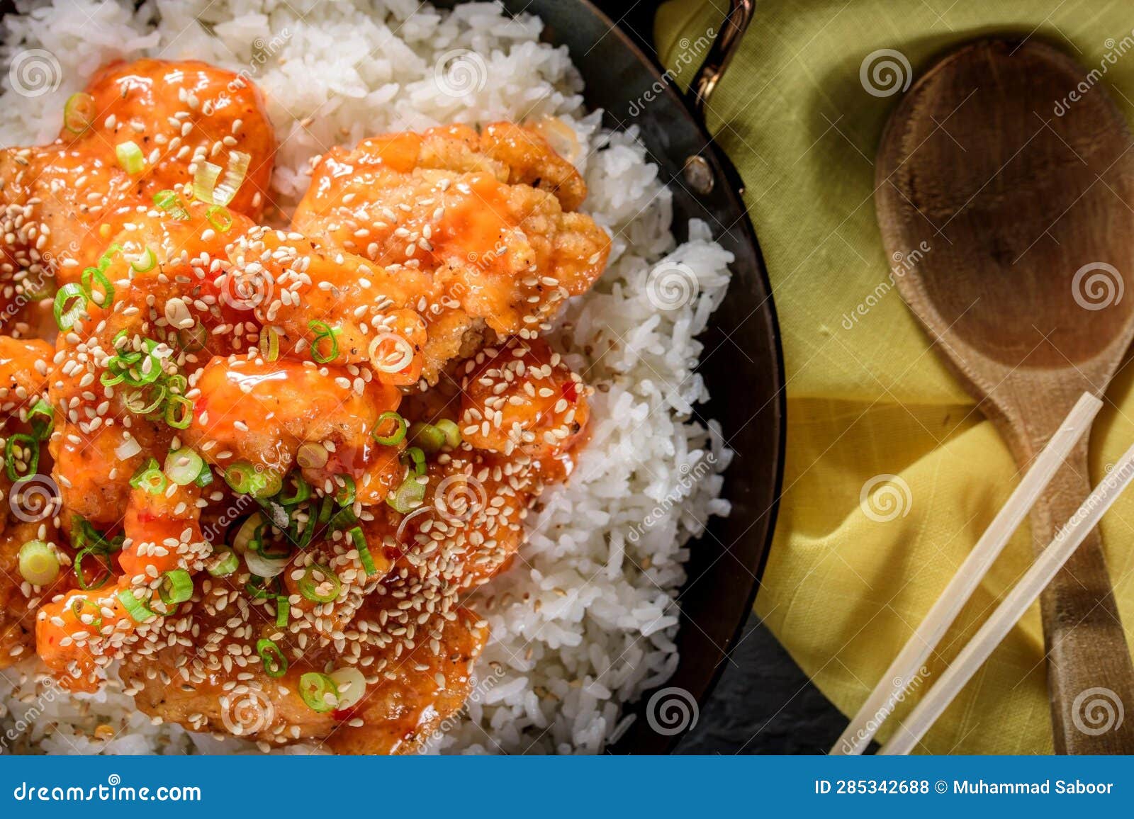 DeepFried Orange Chicken Served on a Bed of Steamed White Rice