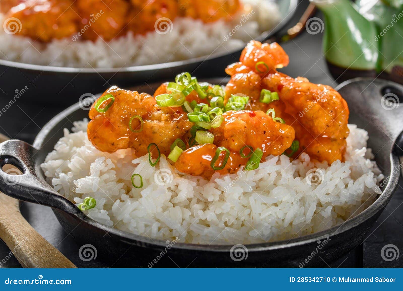 DeepFried Orange Chicken Served on a Bed of Steamed White Rice