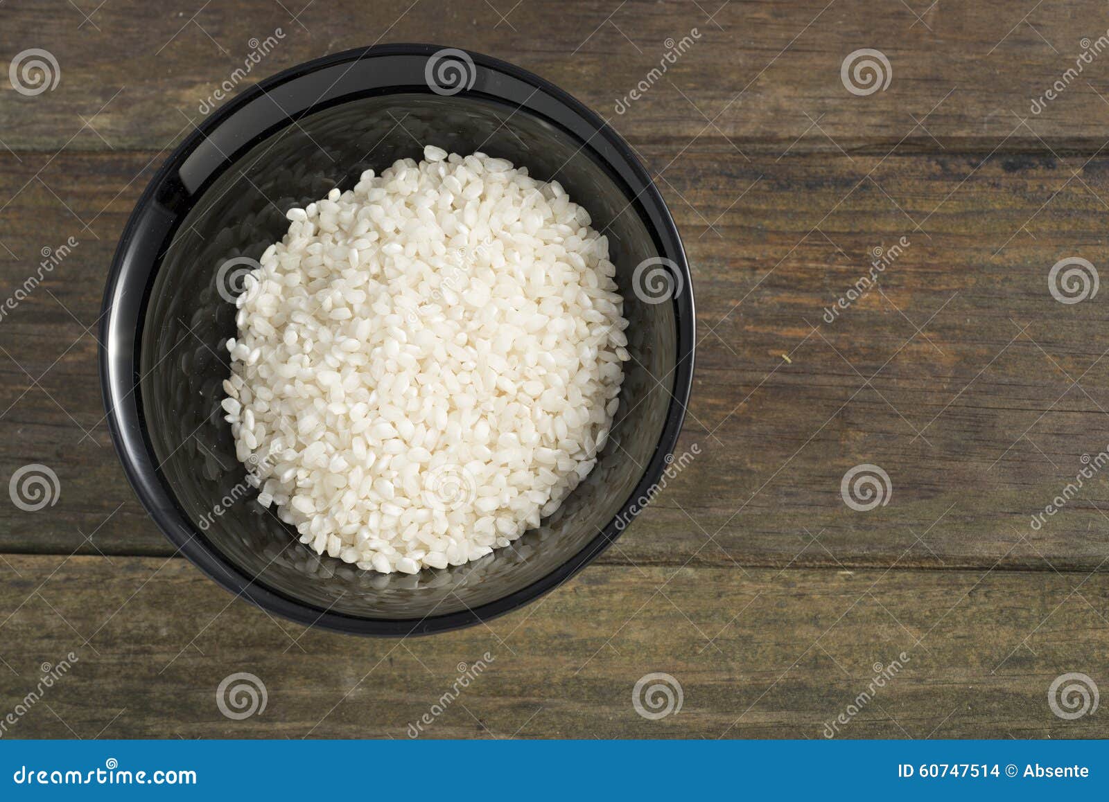 Black bowl full of rice on dark background