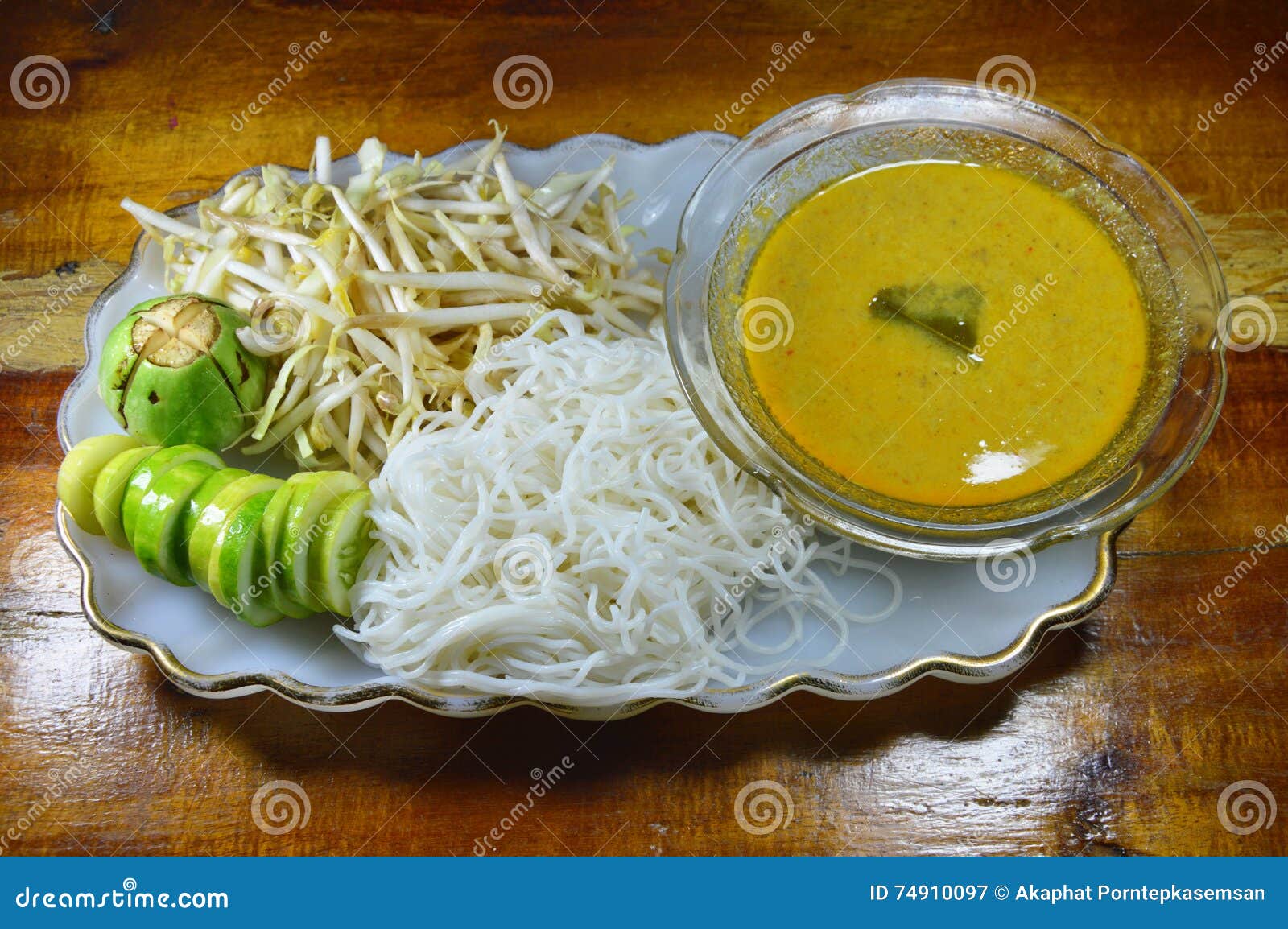Rice Noodle and Fish Curry Sauce Eat with Vegetable on Plate Stock