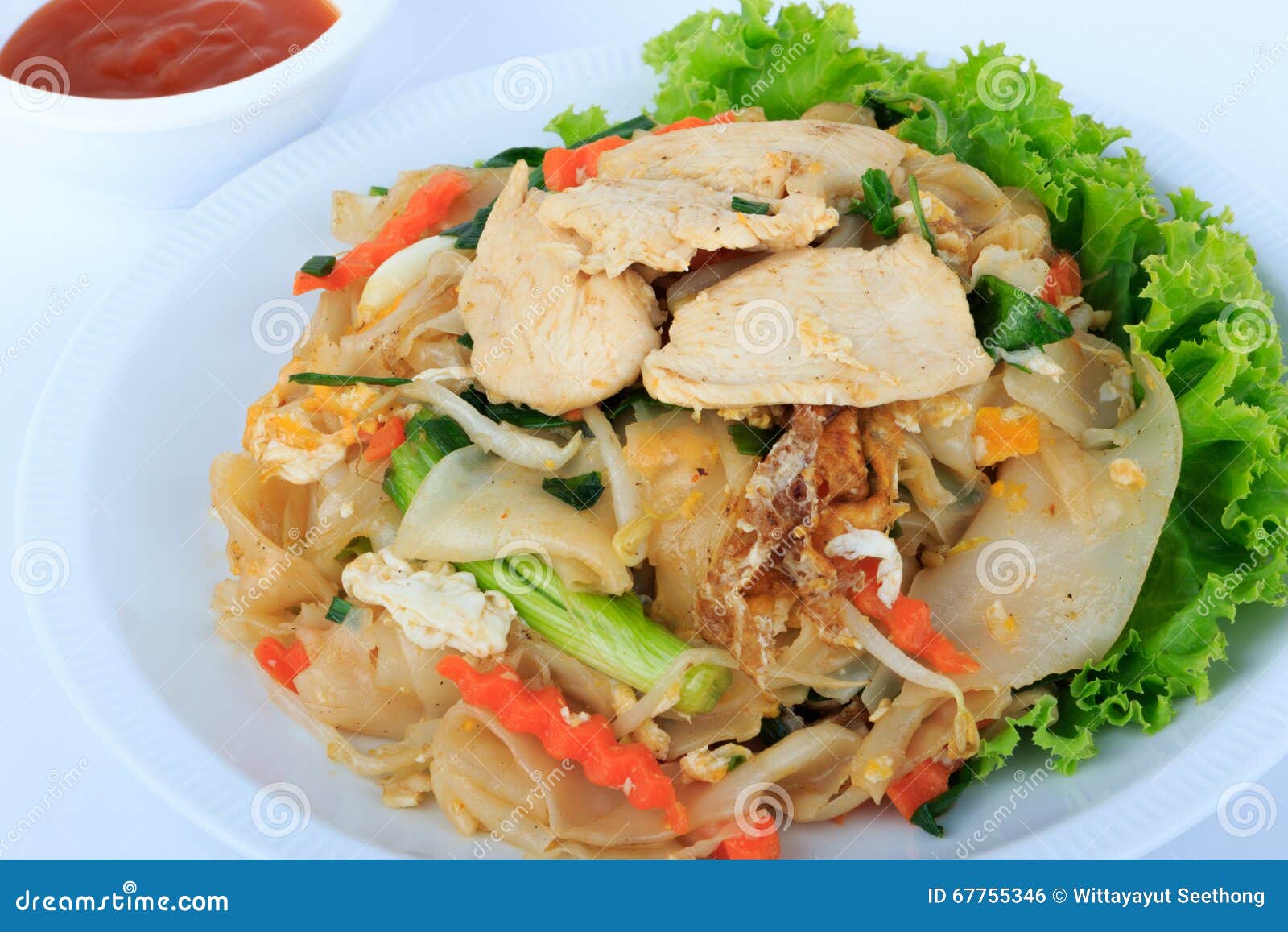 rice noodles stir-fried with chicken. thai street food.