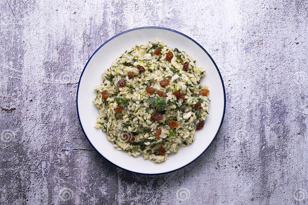 Rice with Spinach and Raisins. Vegan Recipe.. Stock Photo - Image of