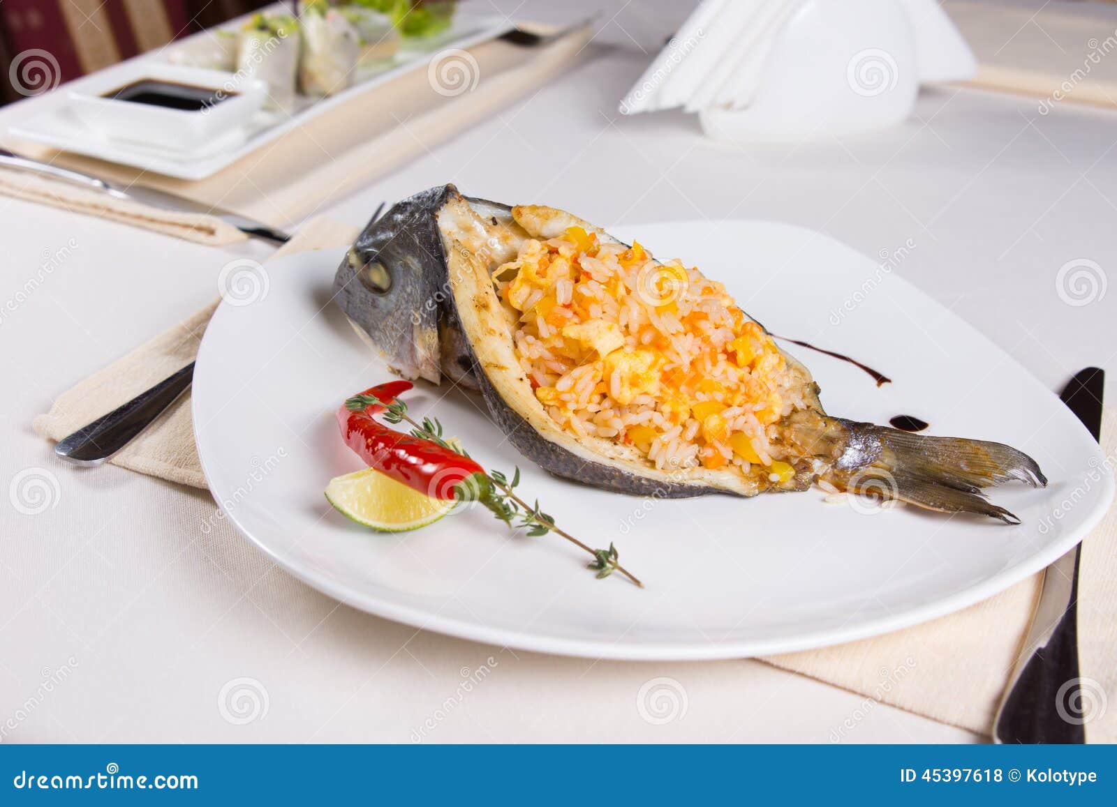 Rice Stuffed Fish Dish on Plate Stock Photo Image of herbs, cutlery