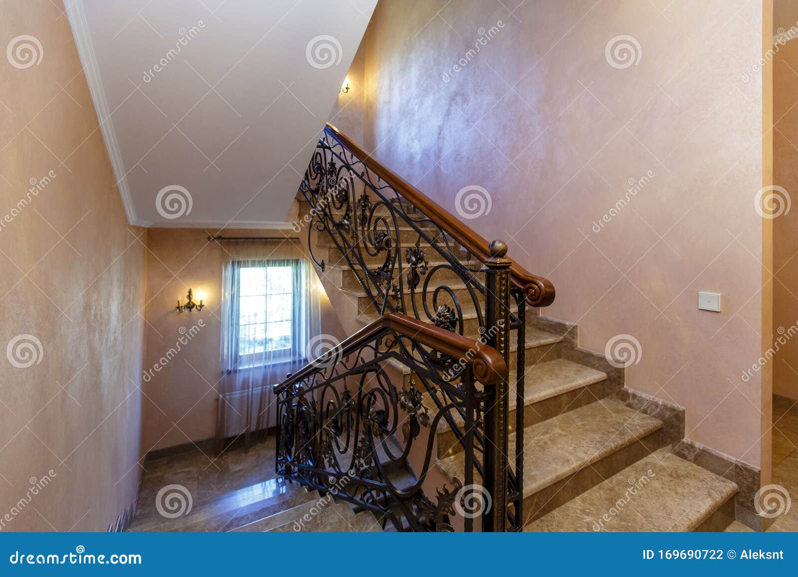 A Rich And Beautiful Staircase With Wrought Iron Railings And A Wooden Handrail Leads To A Landing With Two Wooden Doors Stock Photo Image Of Architecture Hall 169690722