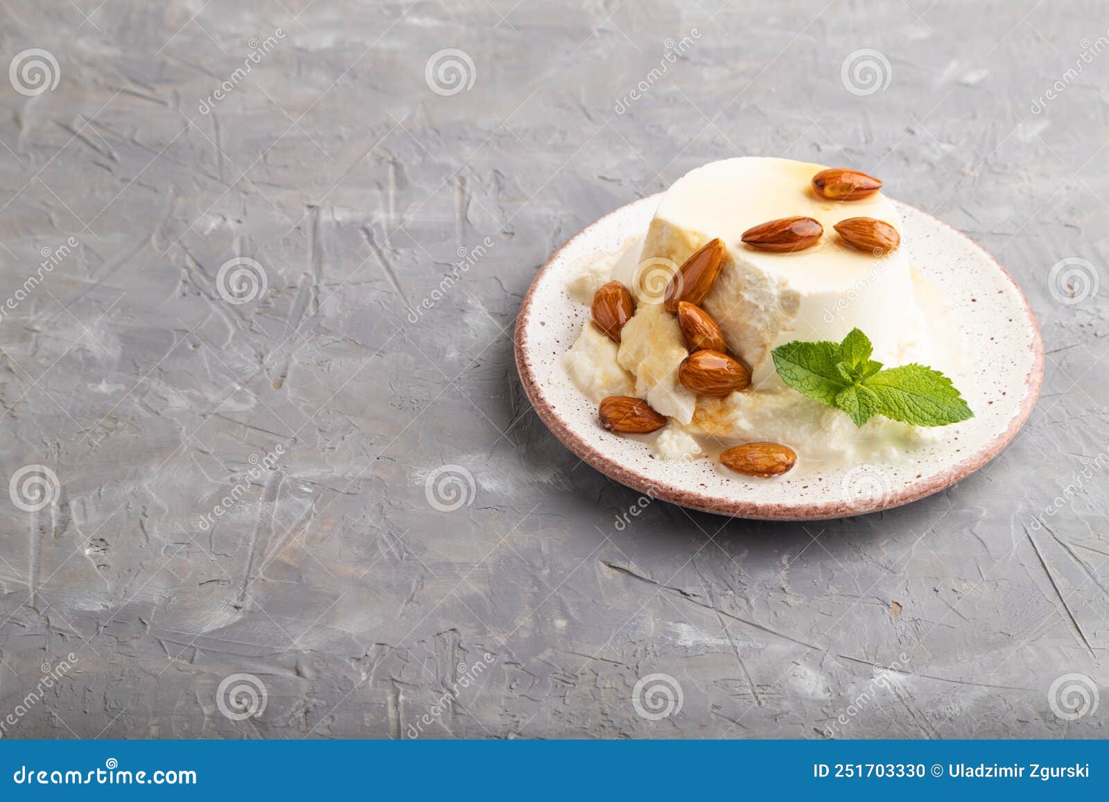 Ricotta Cheese with Honey and Almonds on Gray Concrete. Side View, Copy