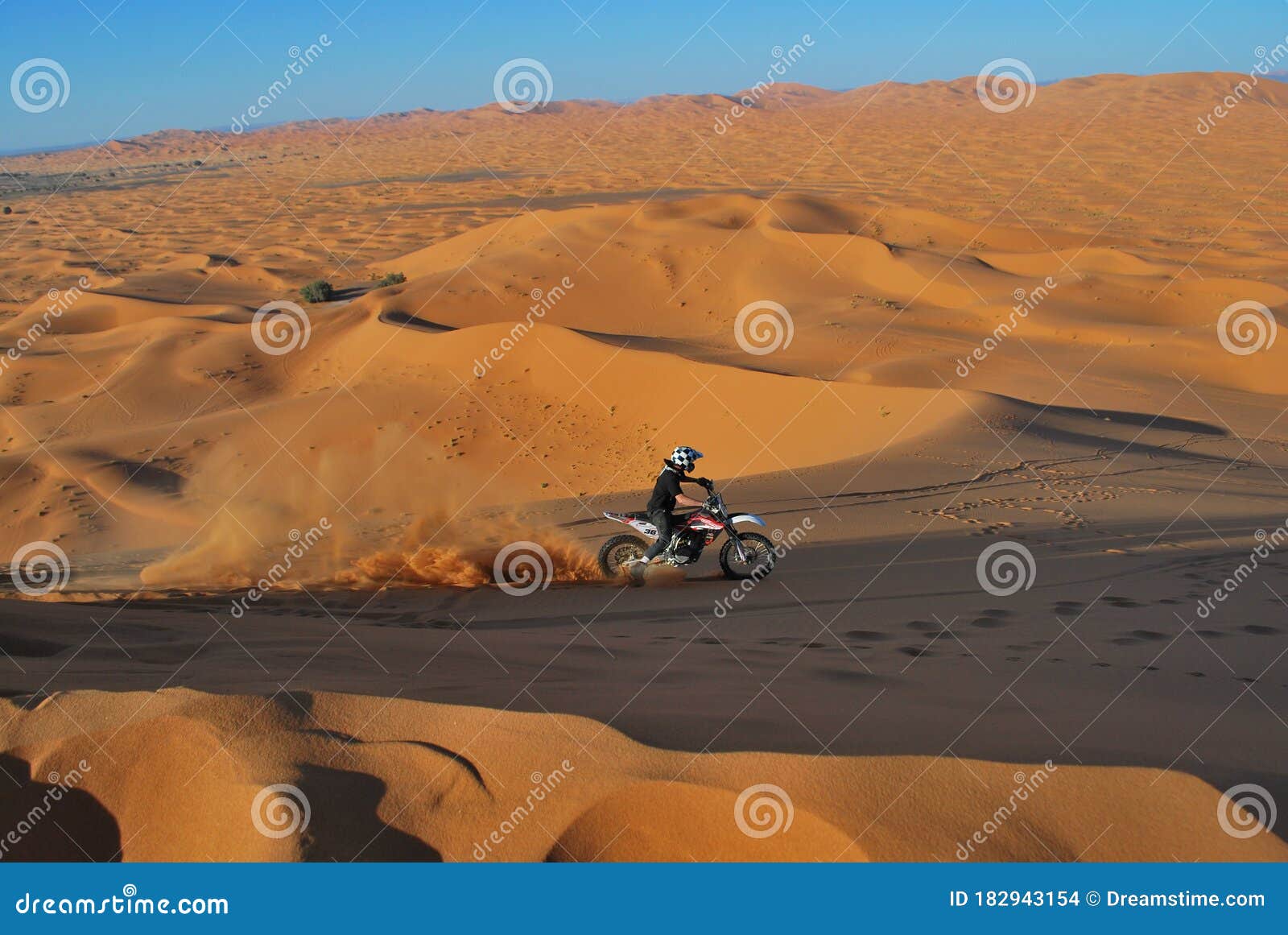 riding motorbike in the sahara dunes