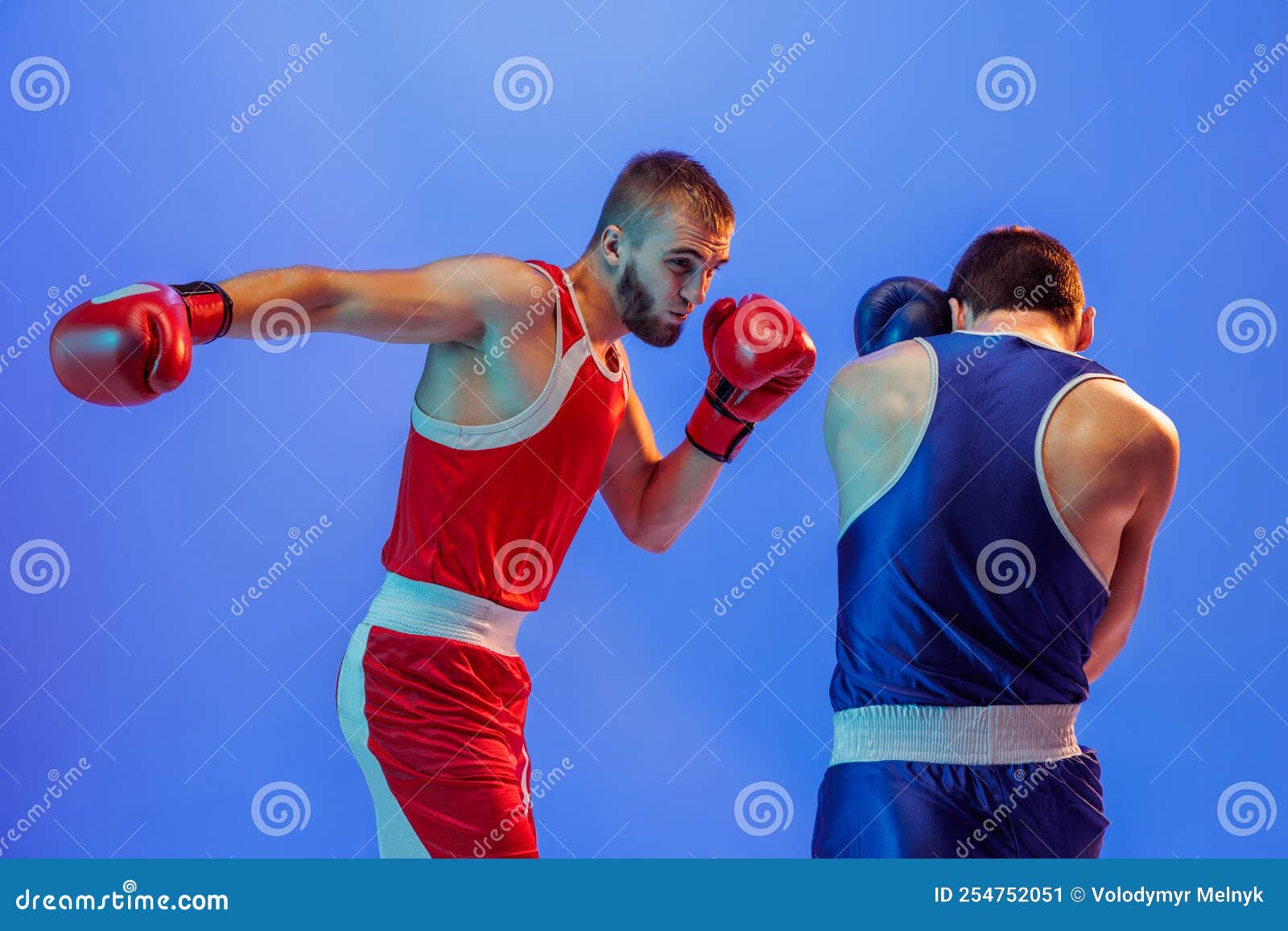 Right Hook. Male Professional Boxers in Red and Blue Sports