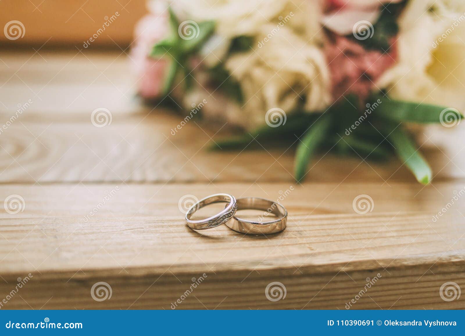 Rings on Wooden Floor with Wedding Flowers Stock Image - Image of rose ...