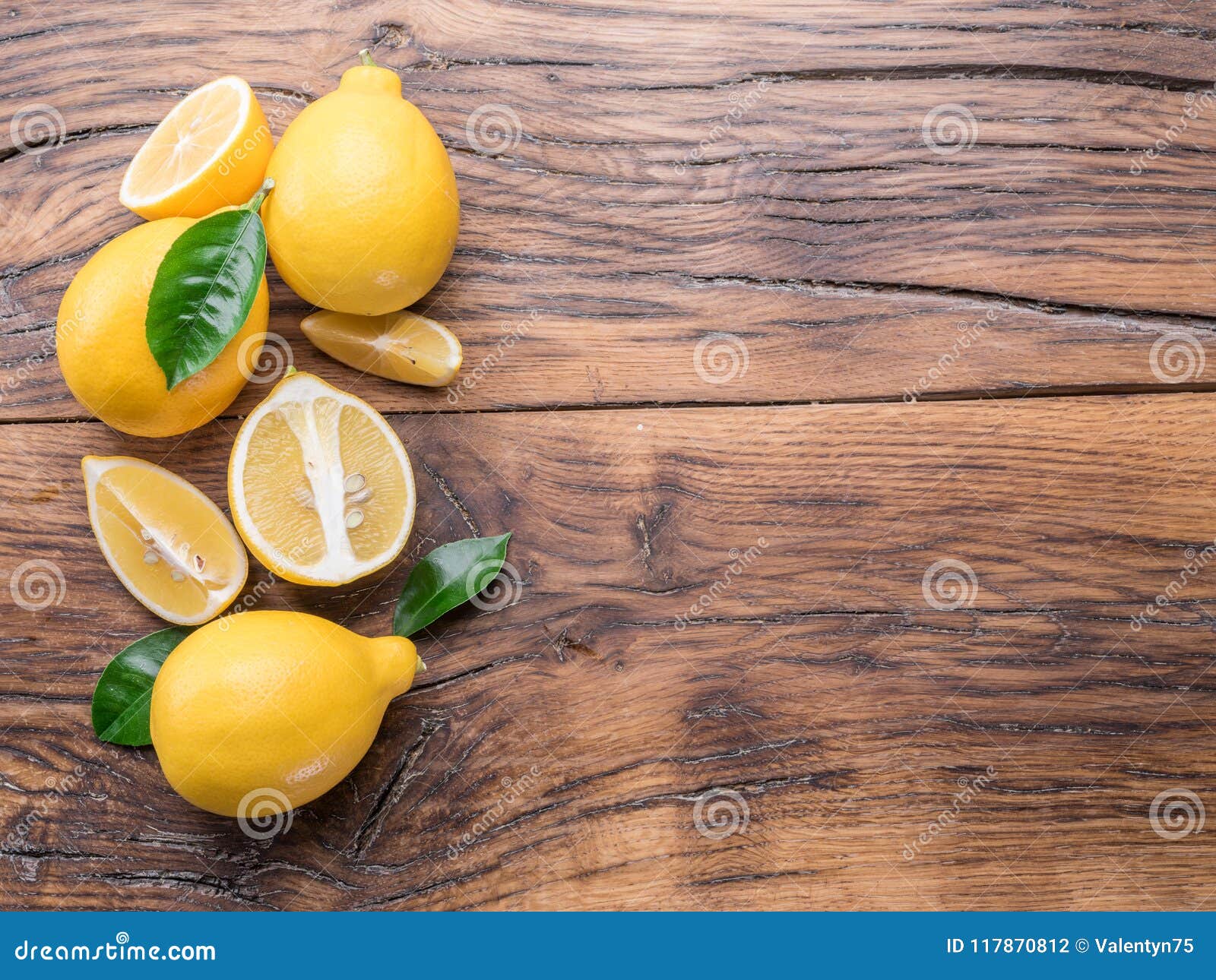 Ripe Lemons and Lemon Leaves on Wooden Background. Top View Stock Photo ...