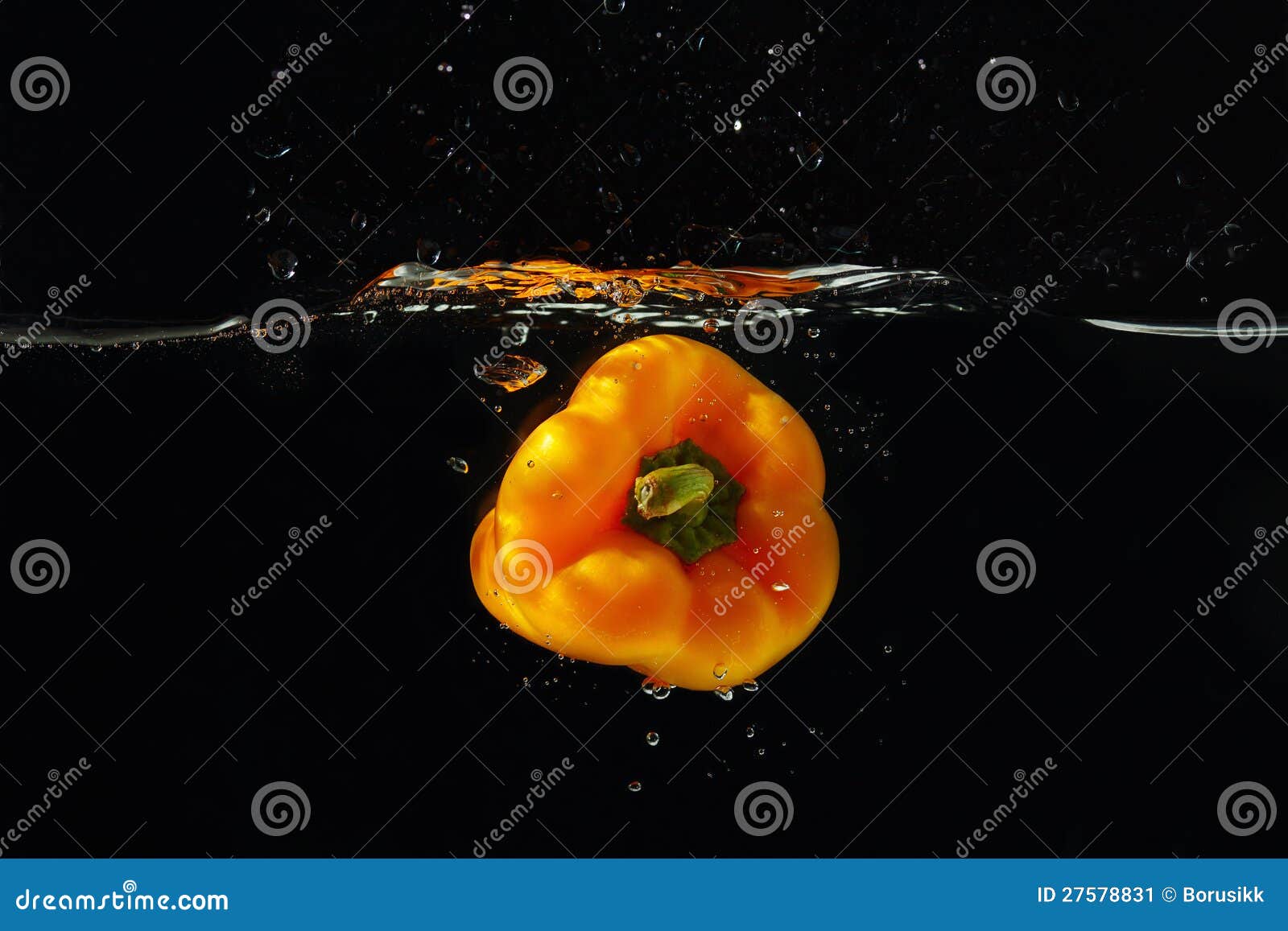 ripe yellow bellpepper falling into the water with splash