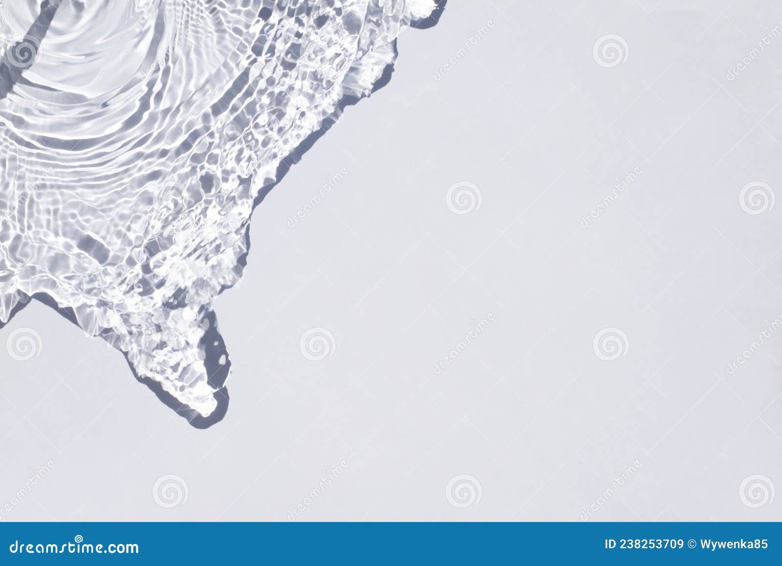 Water Spills on a Light Blue Background. Natural Sunlight and Shade ...