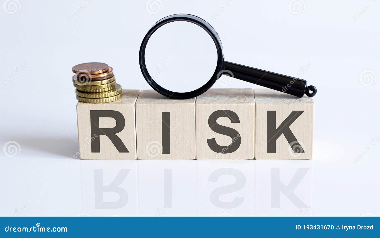 The RISK Sign on a Wooden Block on White Background with Coins and
