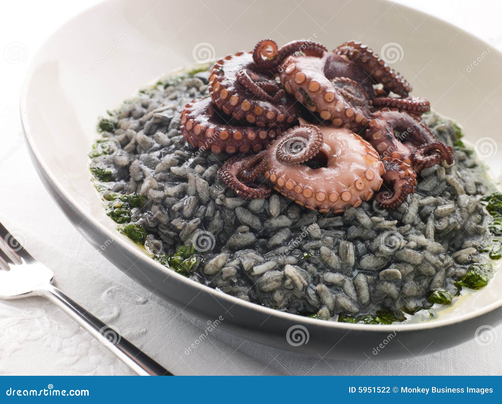 risotto nero with fried octopus and pesto dressing