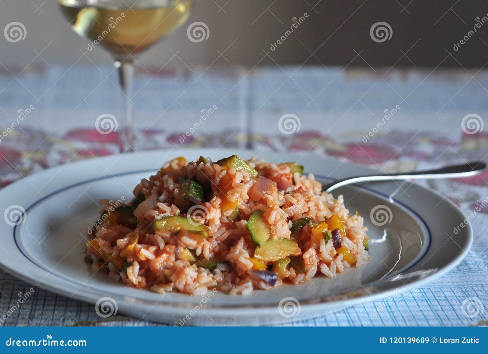 risotto with vegetables zucchini, yellow pepper, red onion and some of tomato sauce ... with a glass of pinot grigio