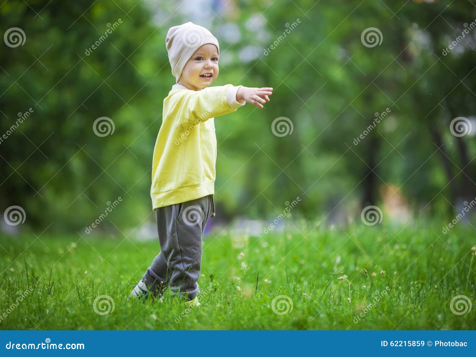 Ritratto di un ragazzino felice che indica a qualcosa all'aperto