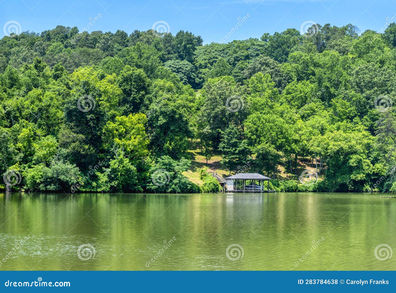 River Background Image with Boathouse at Waters Edge Stock Photo