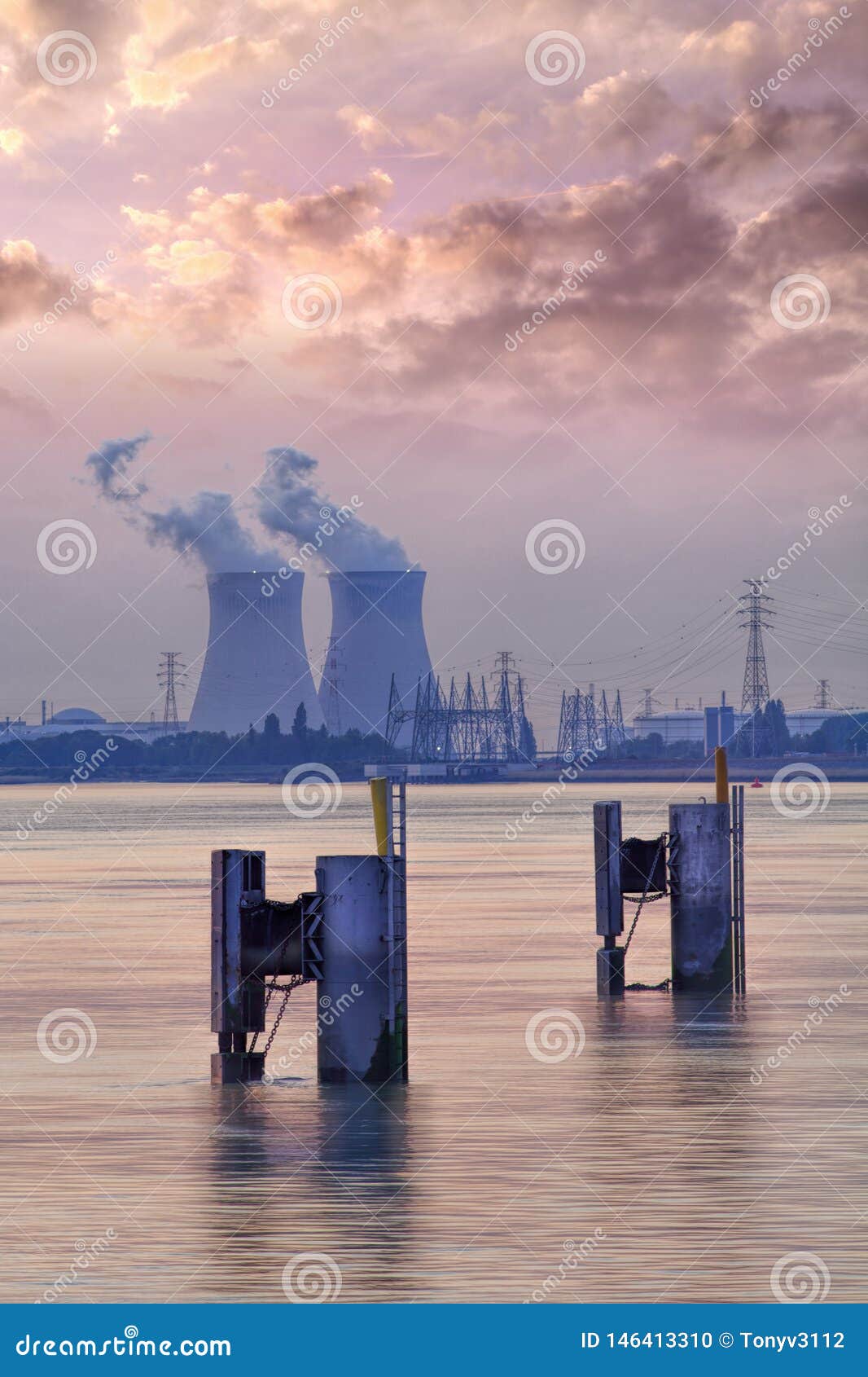 riverbank with nuclear power plant doel during a sunset with dramatic cluds, port of antwerp